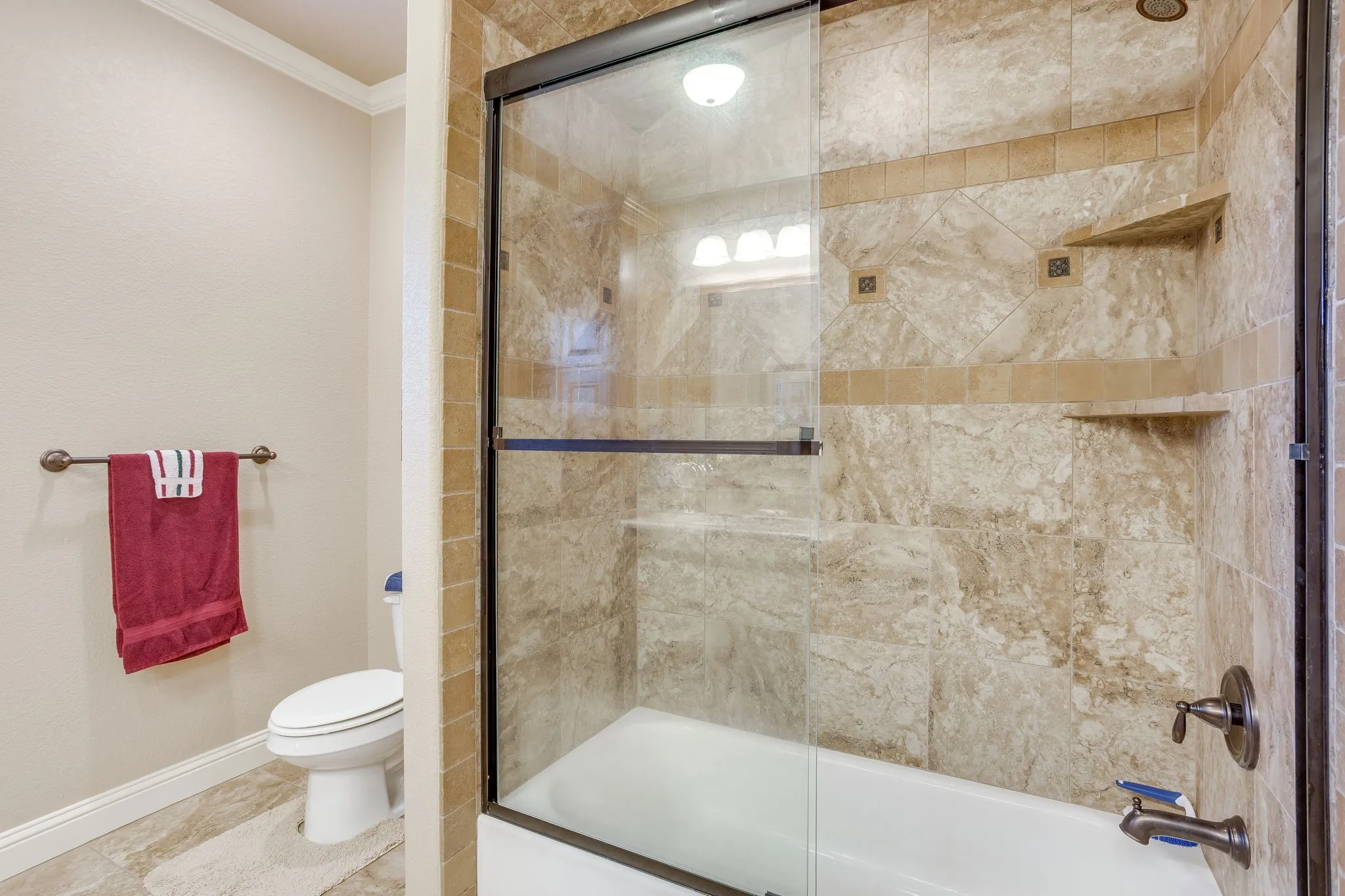 Full bathroom featuring a tub and shower combination with a sliding glass door enclosure