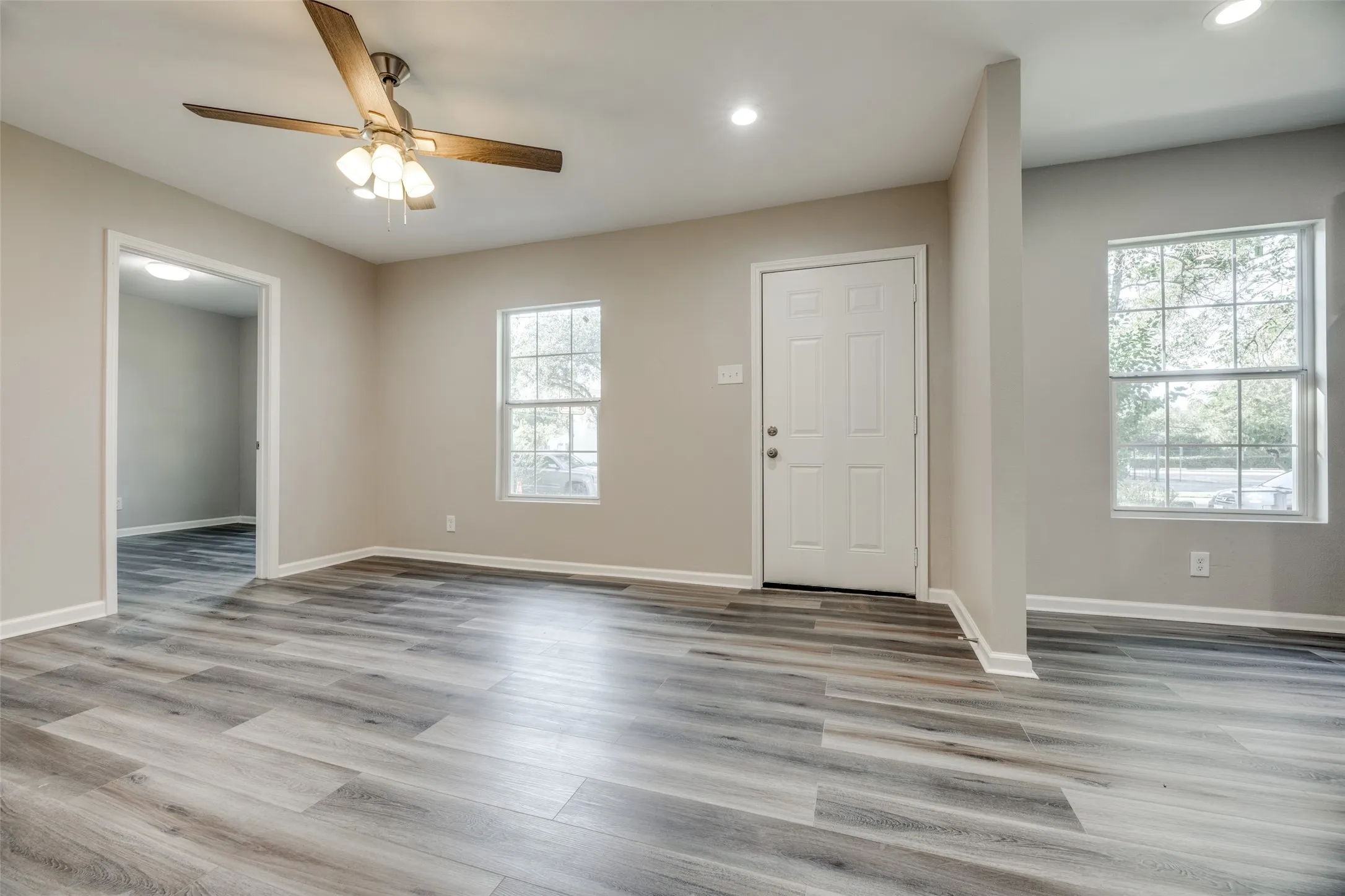 Entrance foyer with wood finished floors, recessed lighting, and ceiling fan