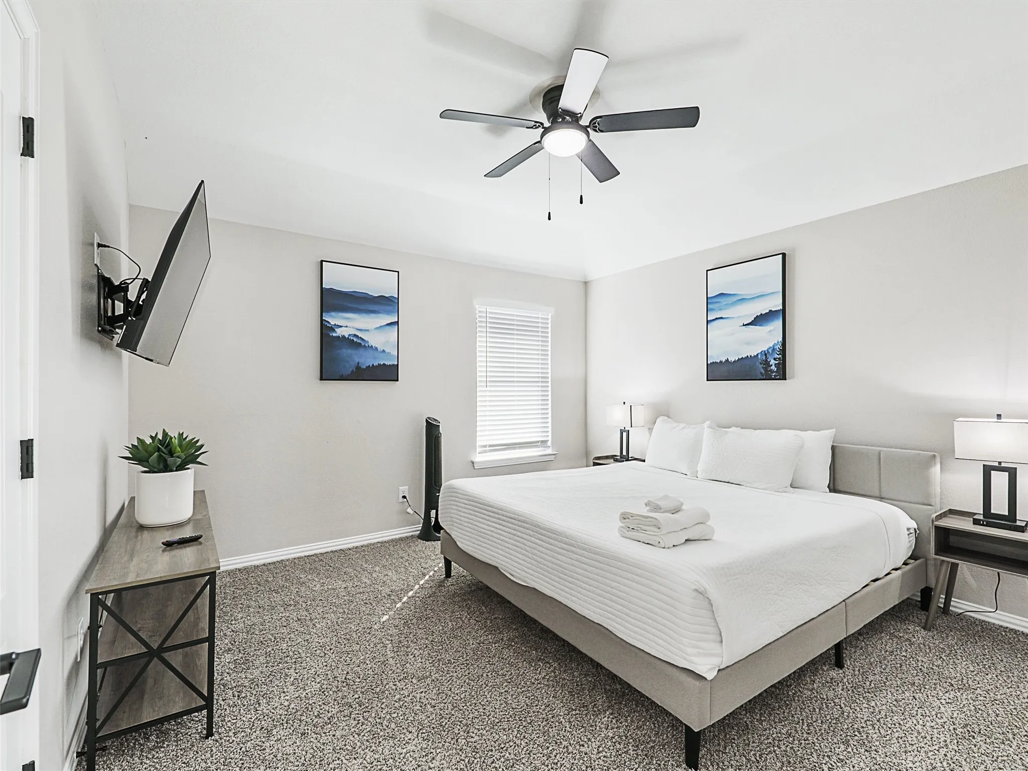 Bedroom featuring textured carpeting and a ceiling fan with integrated lighting