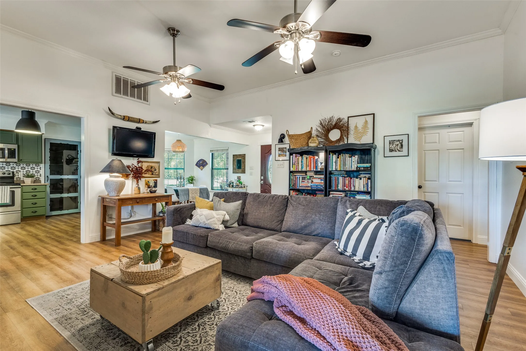 Living room with views into open kitchen and dining areas