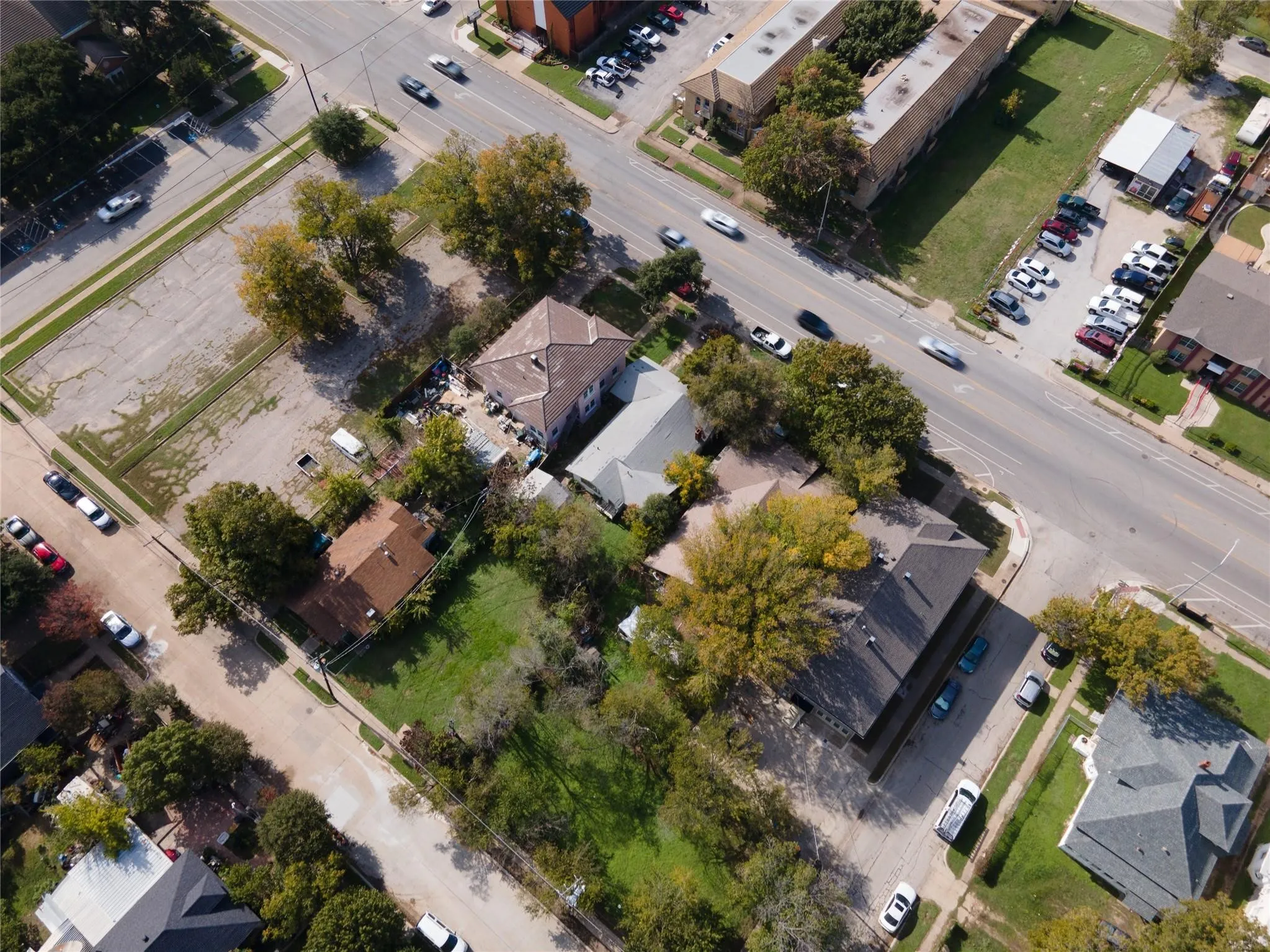 Aerial perspective showcasing multiple properties and a street intersection