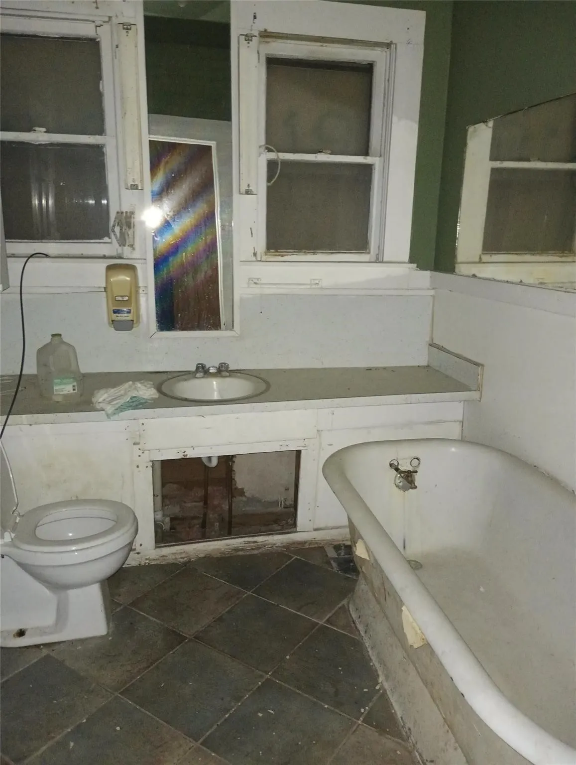 Bathroom featuring a drop-in sink, white toilet, and freestanding bathtub