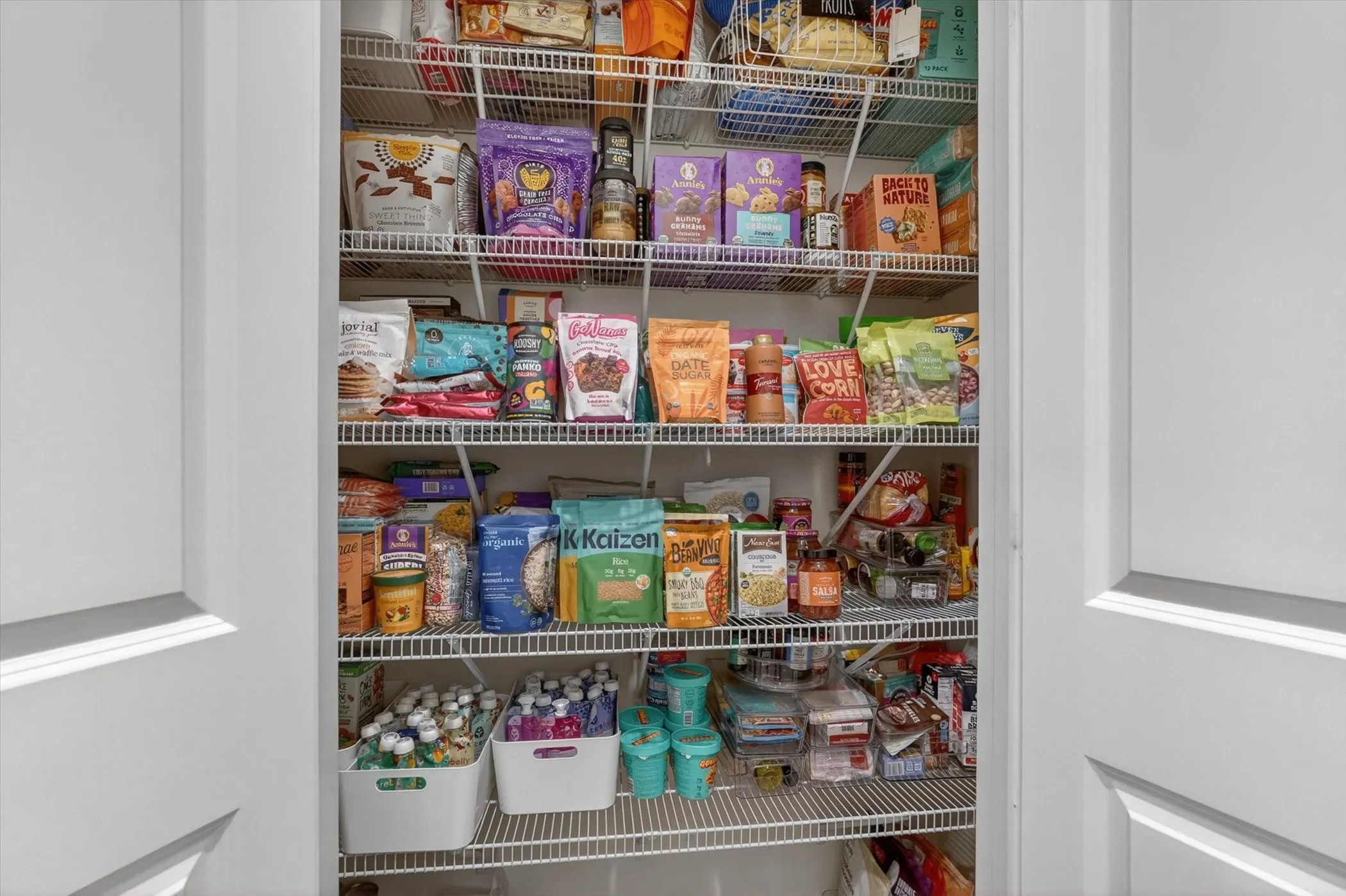 Spacious pantry featuring multiple levels of wire shelving behind classic panel​​‌​​​​‌​​‌‌​‌‌​​​‌‌​‌​‌​‌​​​‌​​ doors