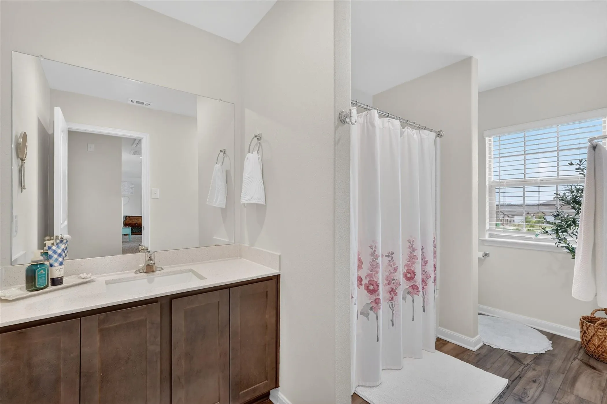 Custom-designed walk-in closet featuring built-in white drawer units, multiple tiers of wire shelving, extensive hanging rods, and soft carpet flooring