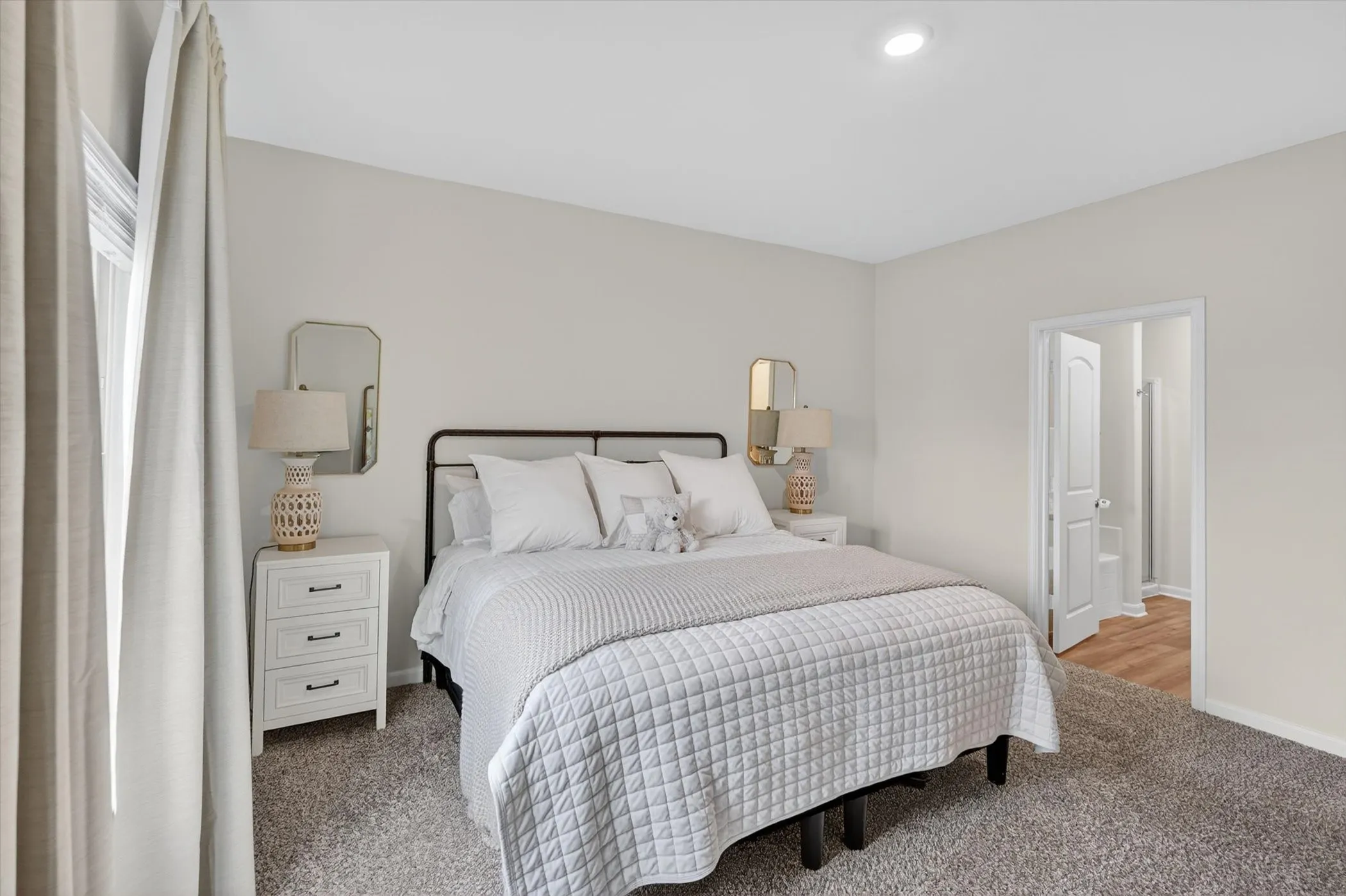 Carpeted room with a recessed light fixture and a window