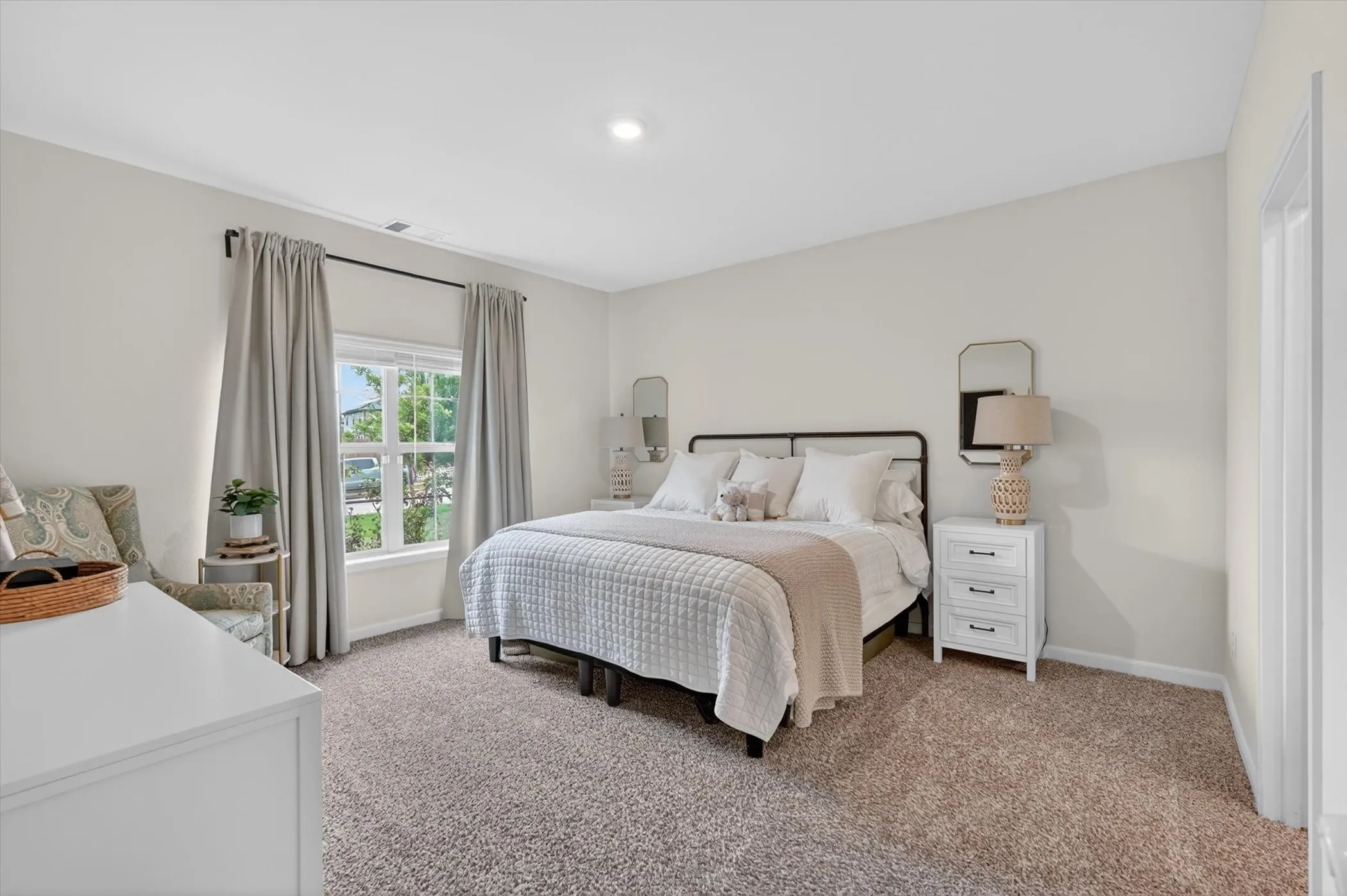 Carpeted bedroom featuring a large window, recessed lighting, and light-toned walls