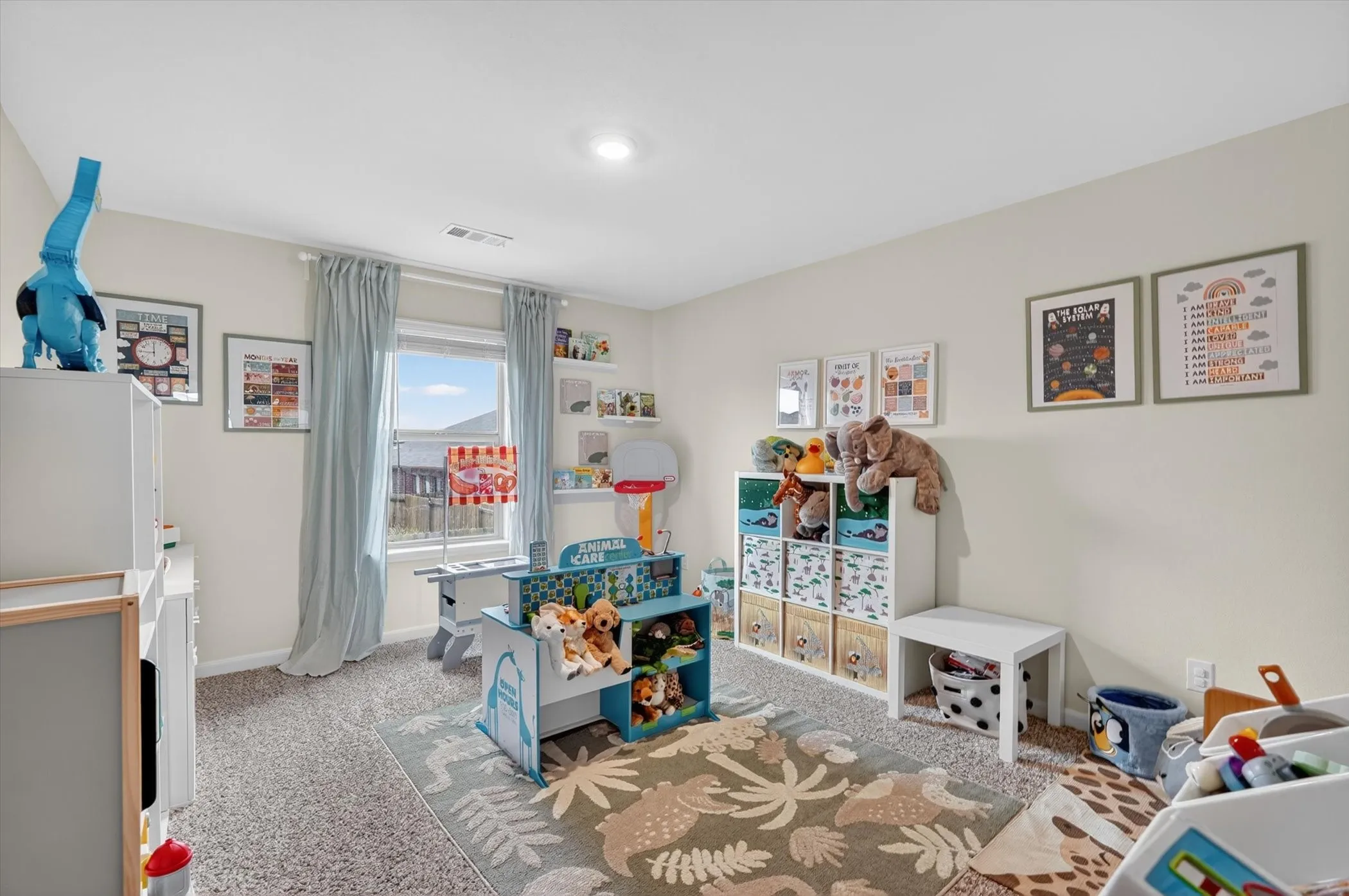 Carpeted room with recessed lighting and a large window