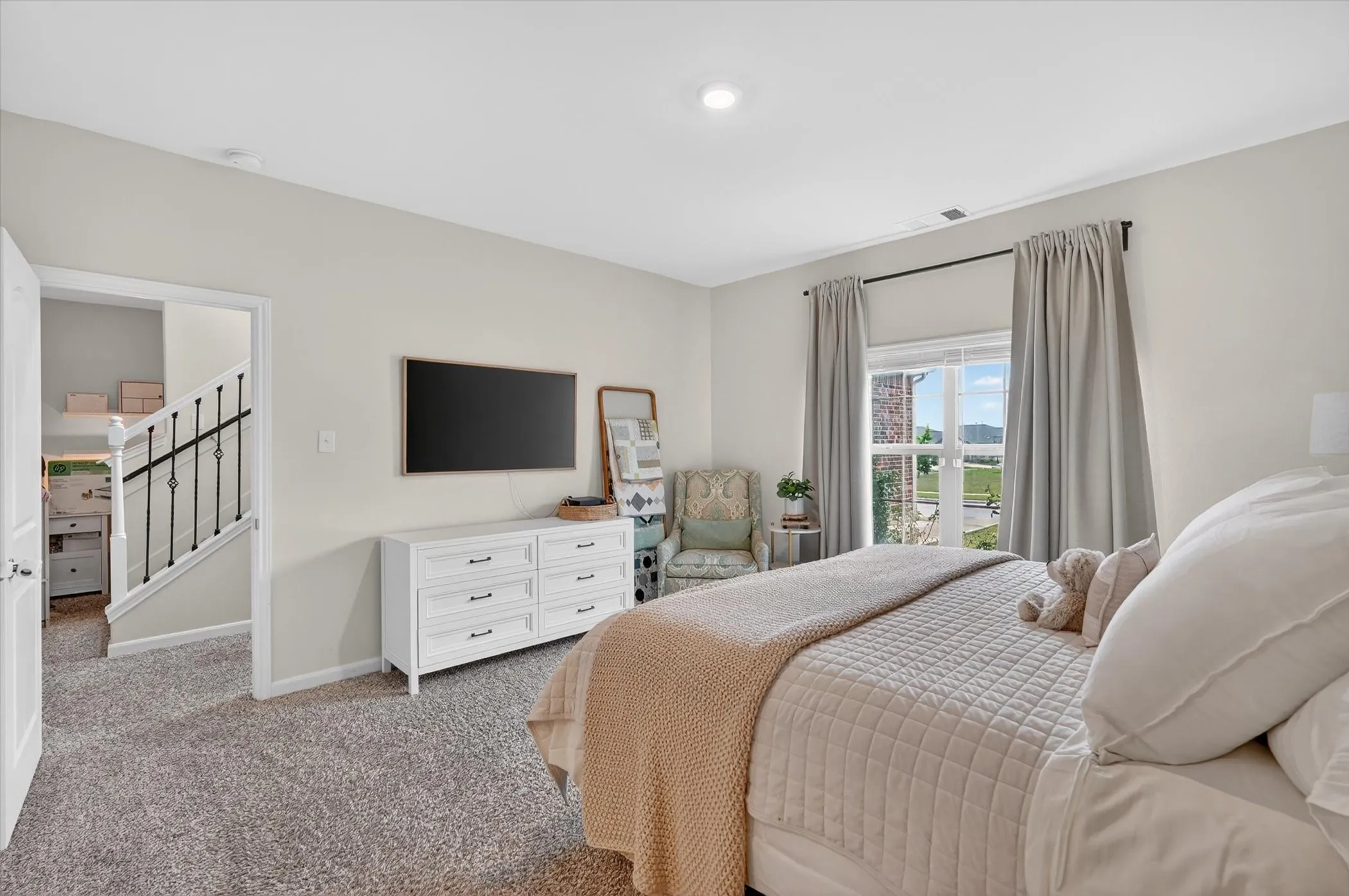 Carpeted bedroom featuring a large window, recessed lighting, and a white six-drawer dresser