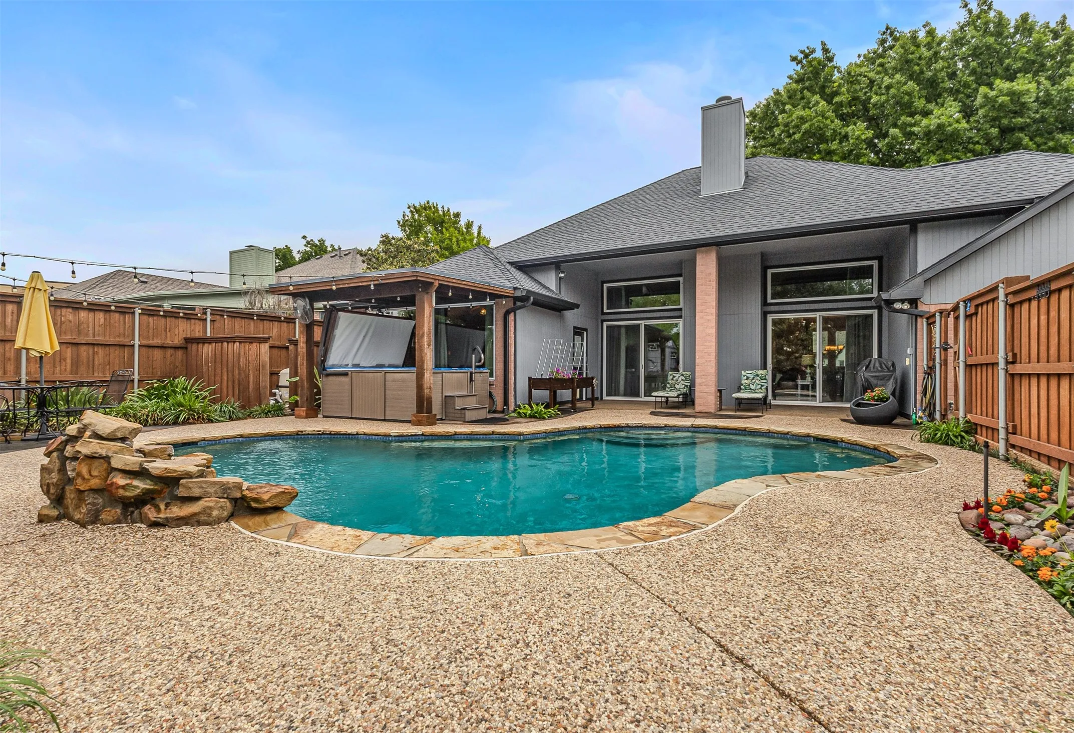 Pergola covered hot tub will convey with home