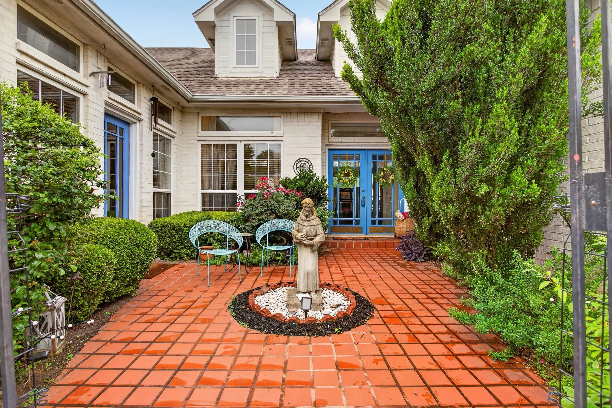Old world charm in this courtyard. We LOVE the classic pop of cerulean blue on the French doors leading to the foyer as well as to the office (or third bedroom).