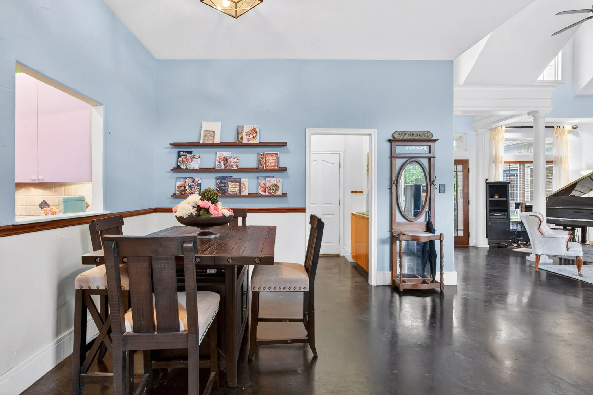 The hall leads to the garage and the spacious laundry room. This area serves as extra dining with a pass-through to the kitchen.