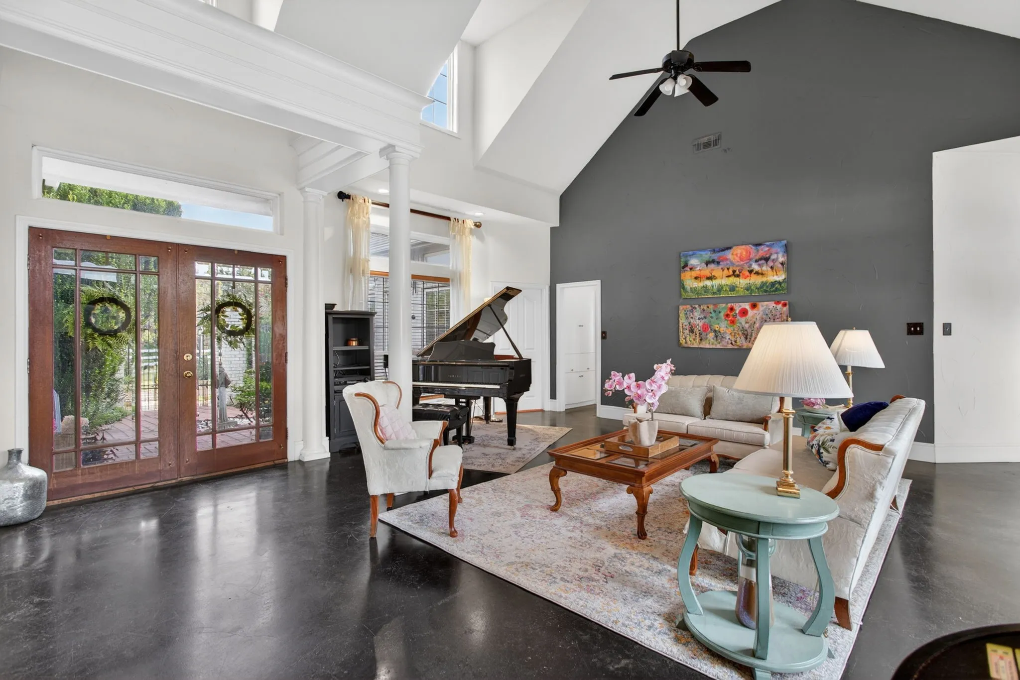 The double doors lead into a light-filled entry with high ceilings and views to the backyard.