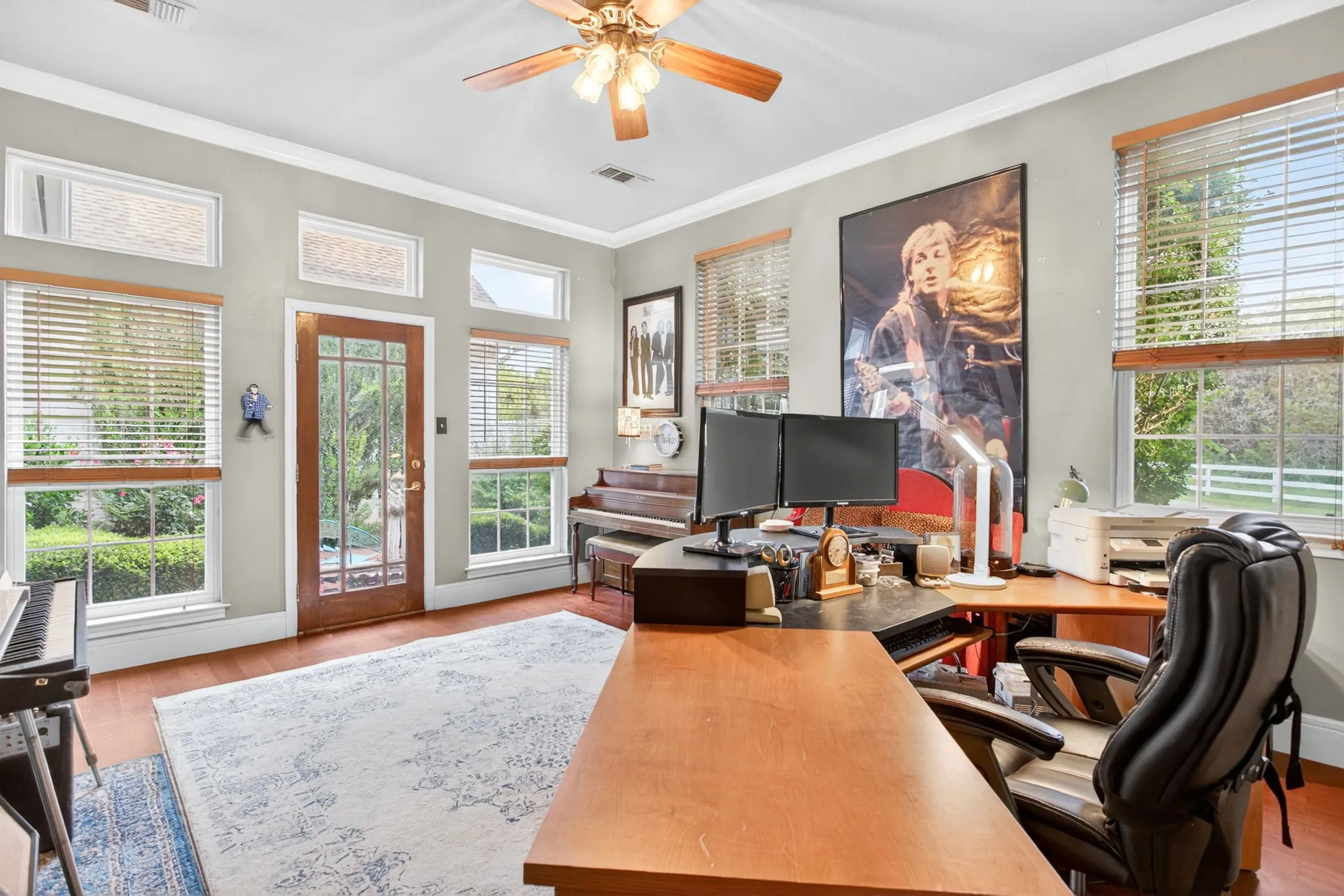 Transom windows and a French door lead to the courtyard; custom details and natural light.