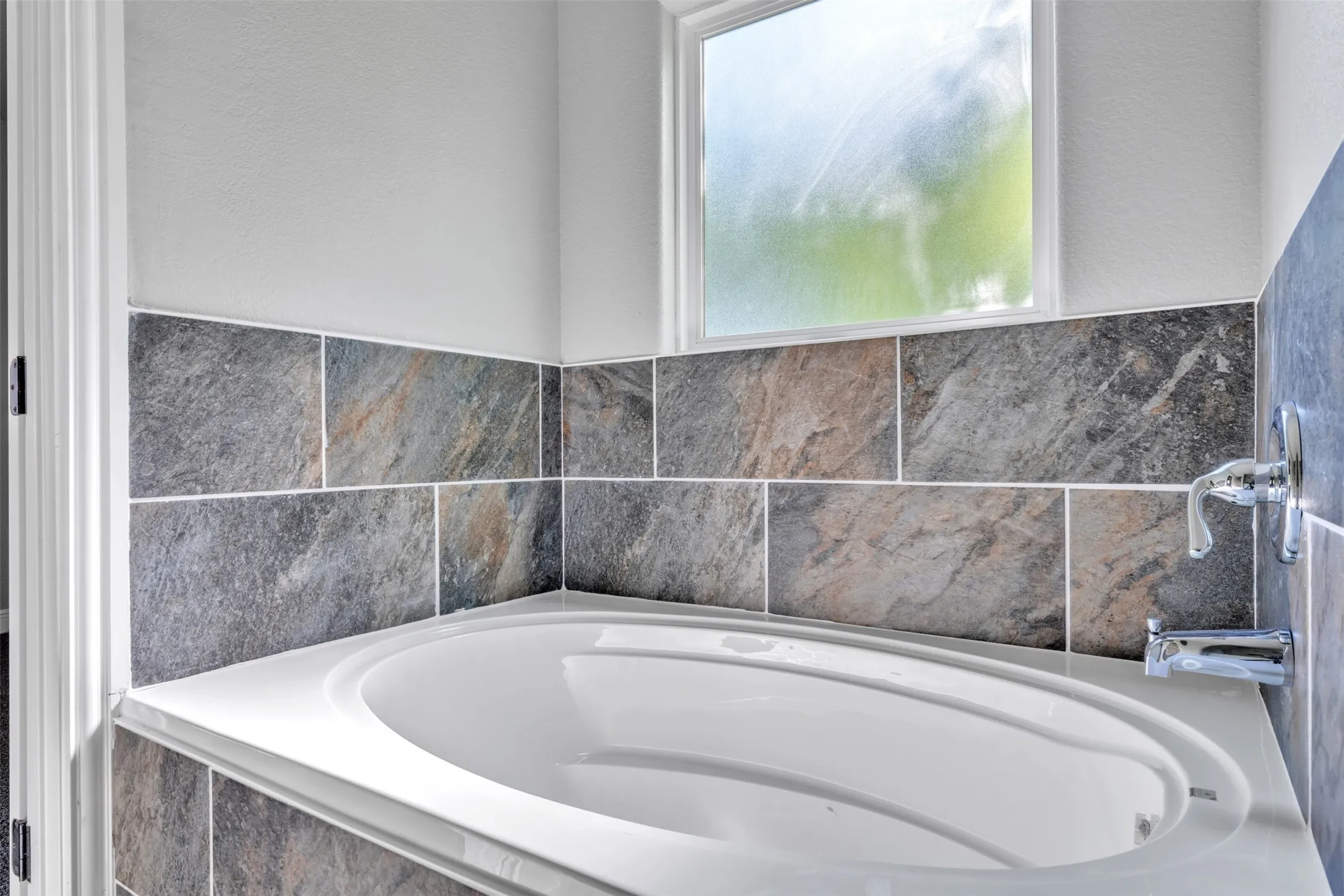 Corner soaking tub with a white finish