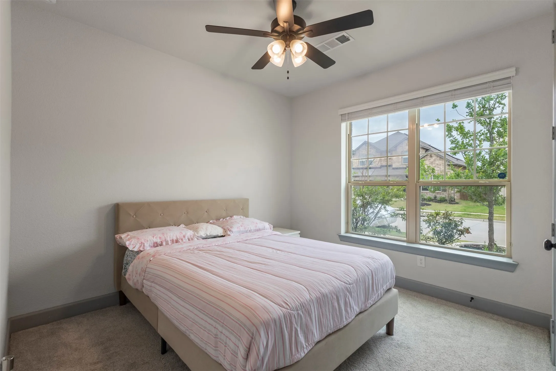 Secondary Bedroom downstairs with large window to let in lots of sunlight