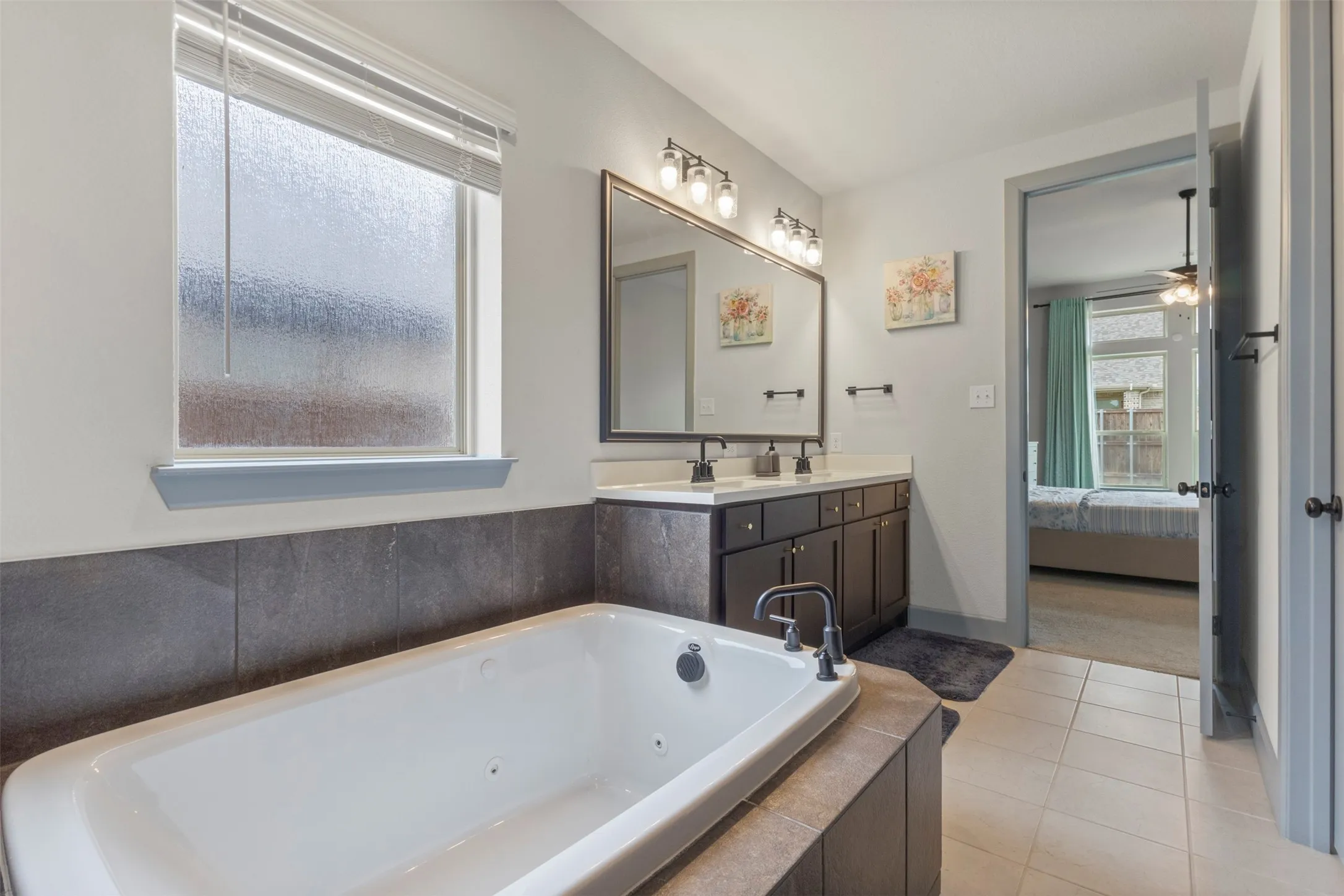 Deep soaking tub with dark tile surround