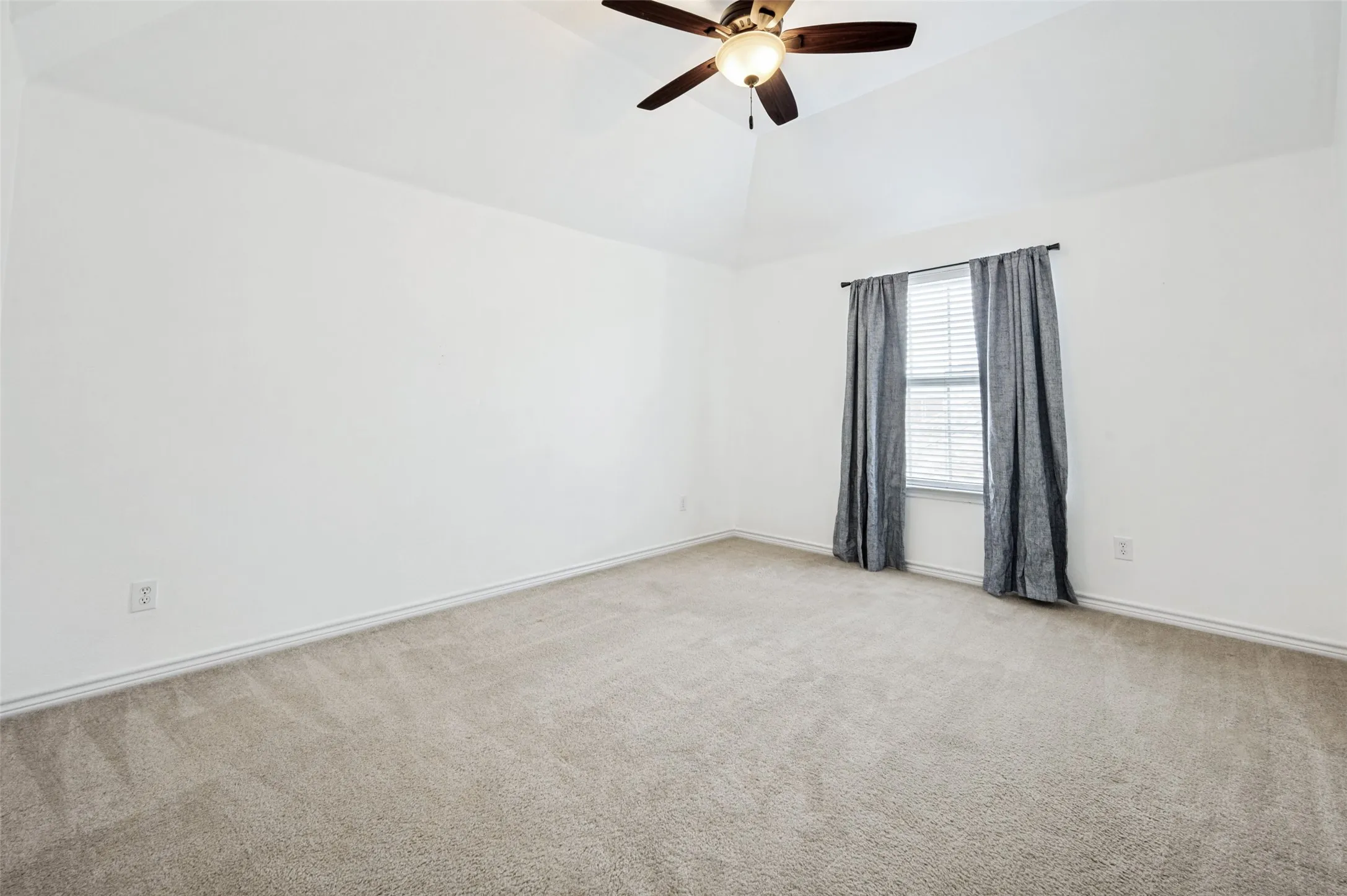 Room with light beige carpeting and white walls