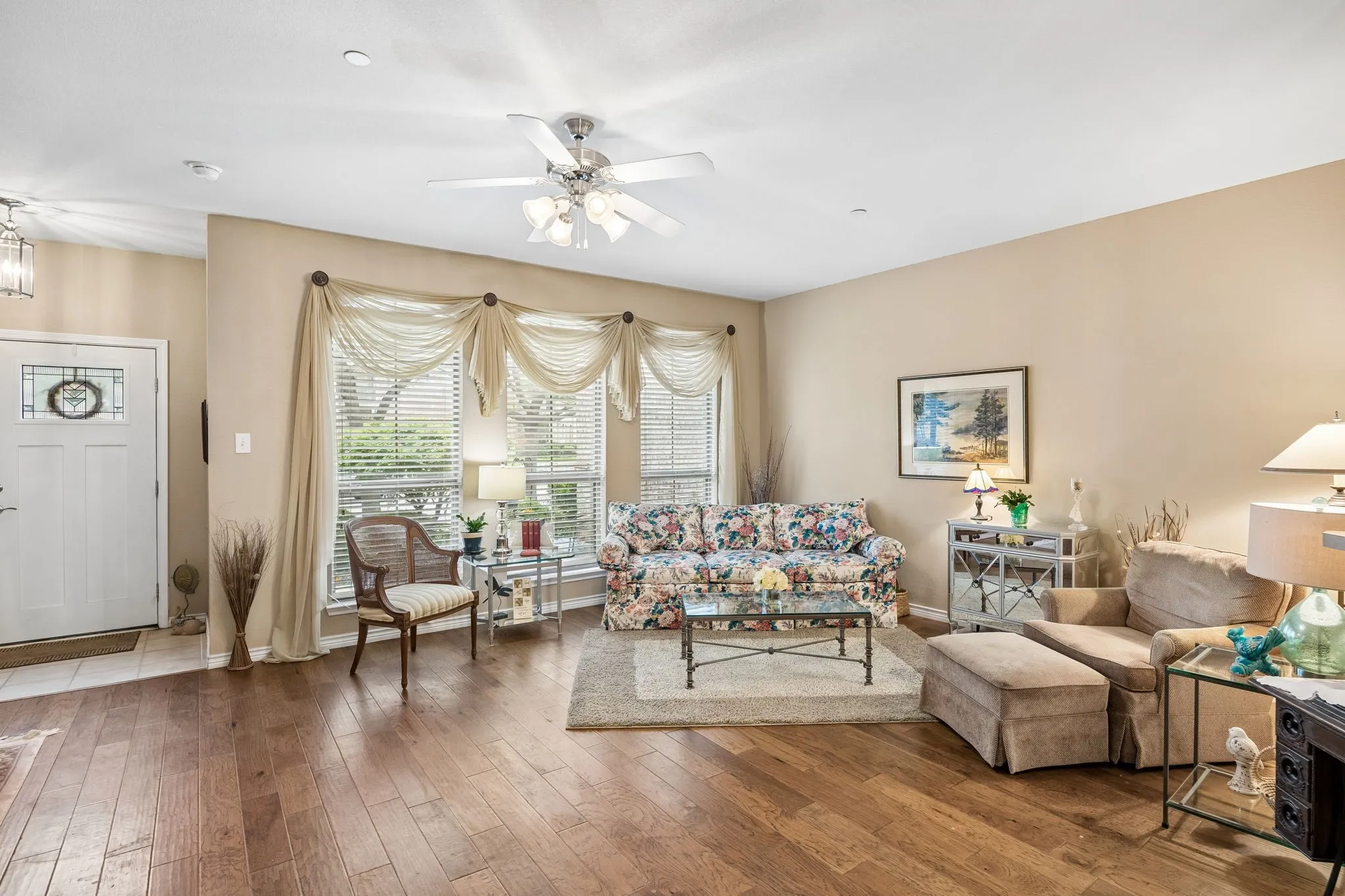 The Light-filled front living area has large front windows and warm, welcoming finishes throughout.