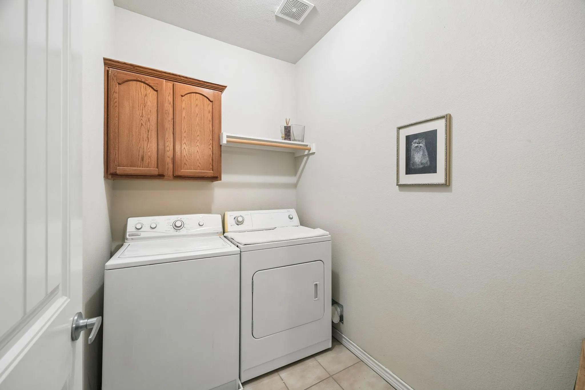 Dedicated utility room with upper storage cabinetry - tucked away between both Upstairs Primary Bedrooms for convenience!