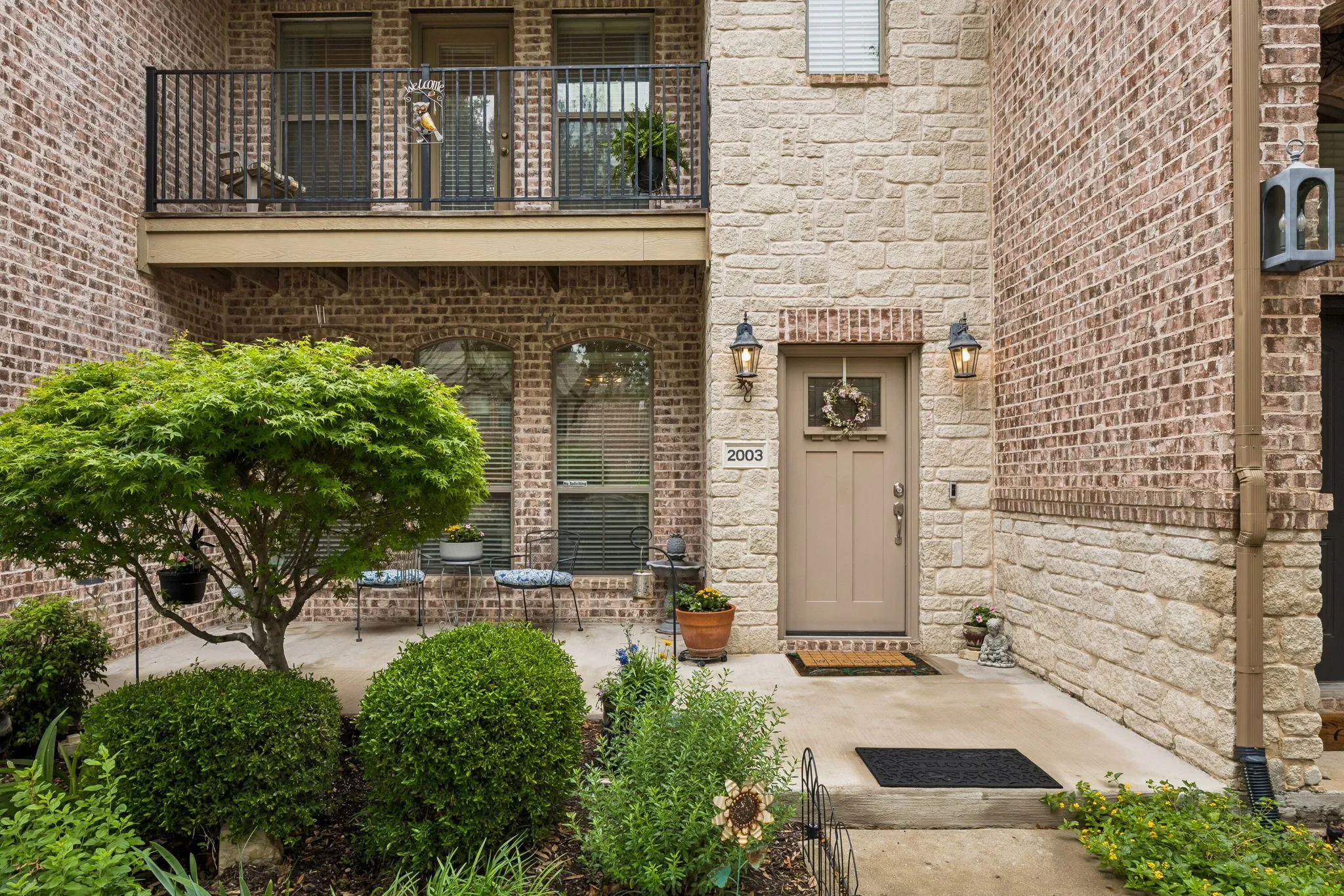 The charming entry has beautiful architectural accents and the landscaped front patio offers a warm, welcoming, and refined first impression.