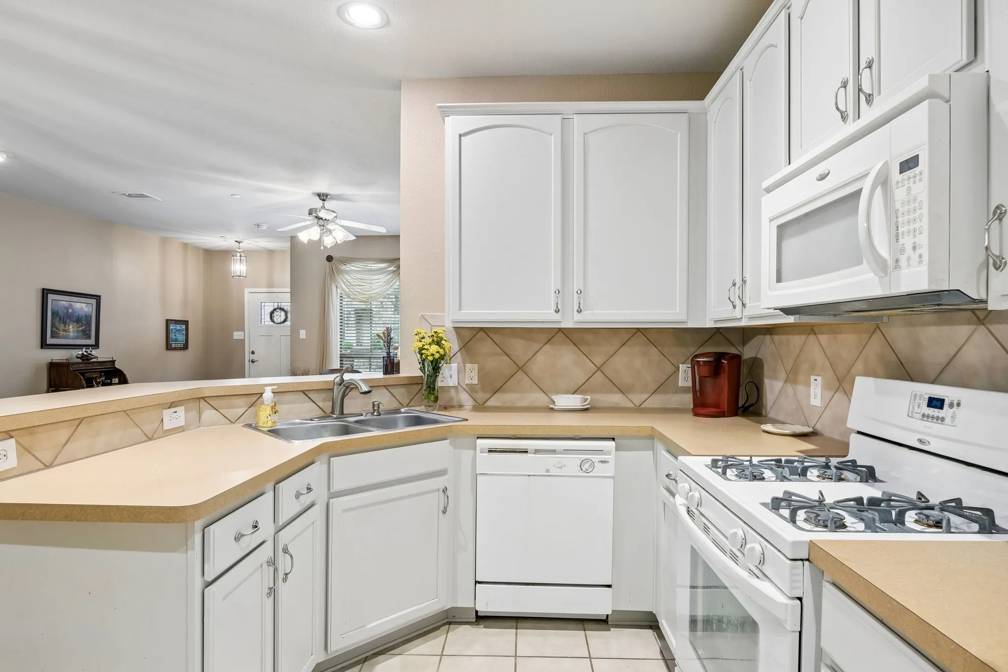 Well-designed kitchen with generous cabinet storage, breakfast bar, and easy flow to the living areas.