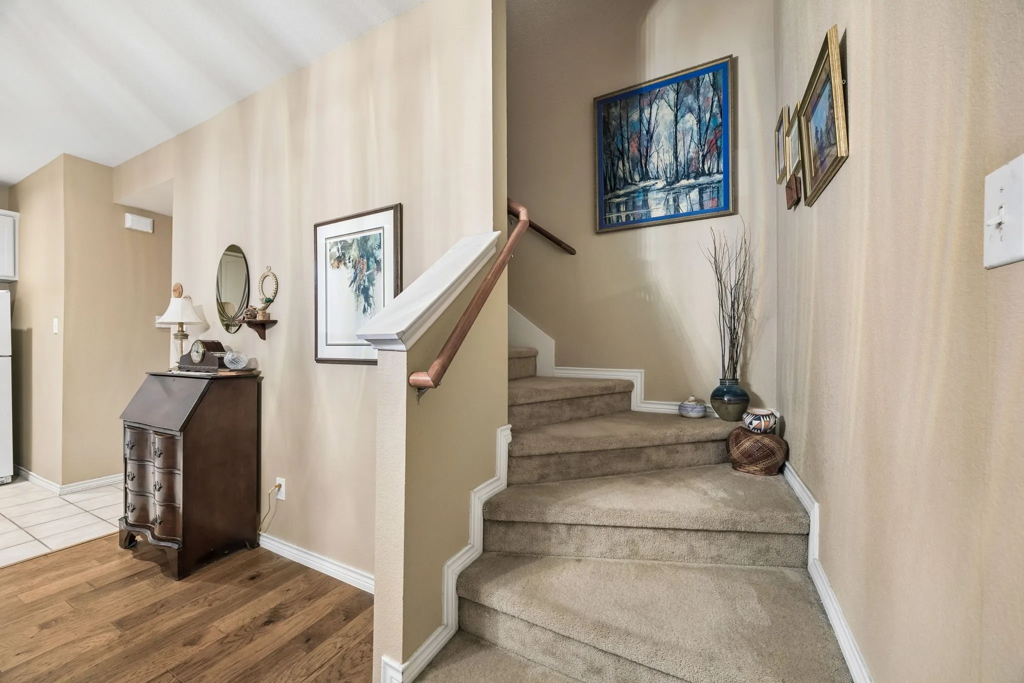 Inviting stairway with soft neutral tones, and an elegant transition to the upper level.