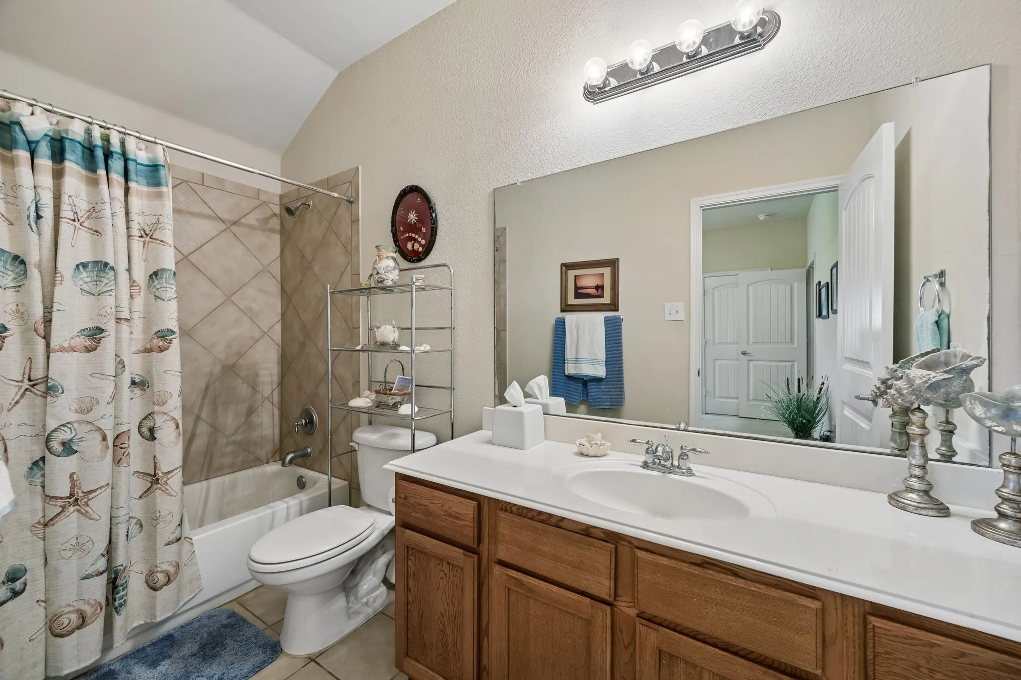 This striking ensuite bath has lots of needed counter space and attractive bath/shower!