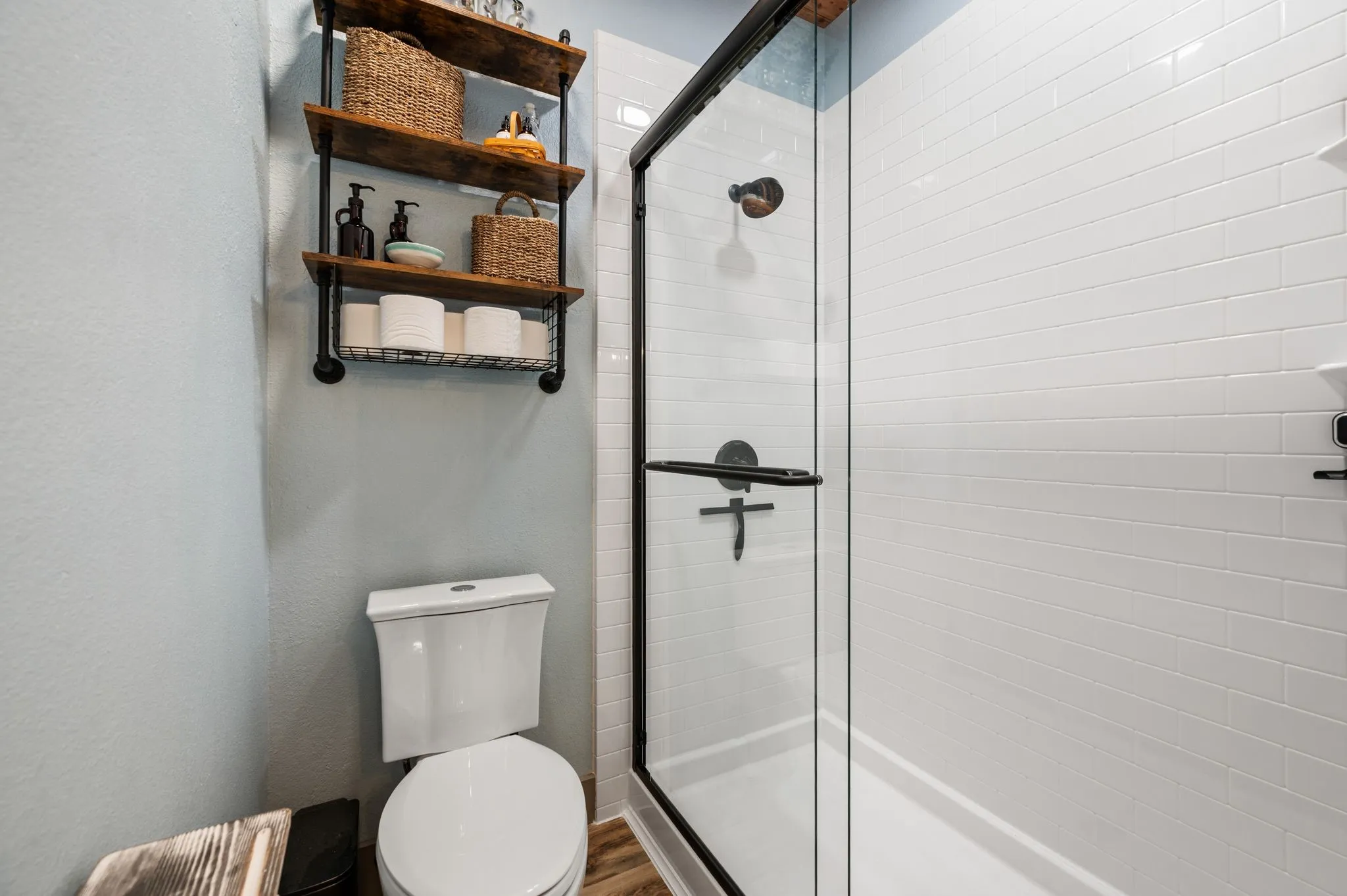 The Primary bath includes a separate Jaccuzi built shower installed in 2024, shelving and a dual flush elongated toilet.