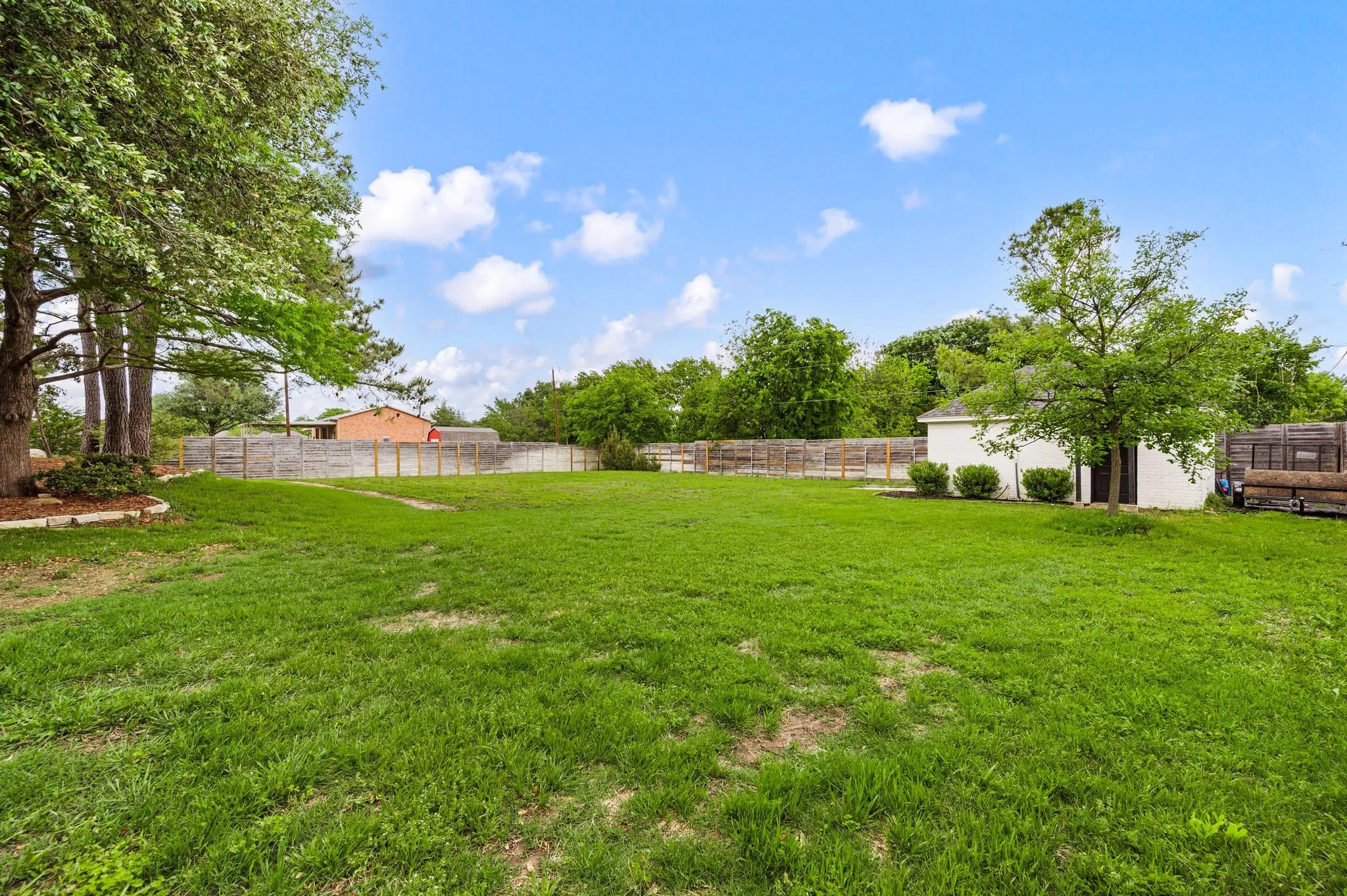Enjoy a huge, private fenced backyard and spacious workshop.