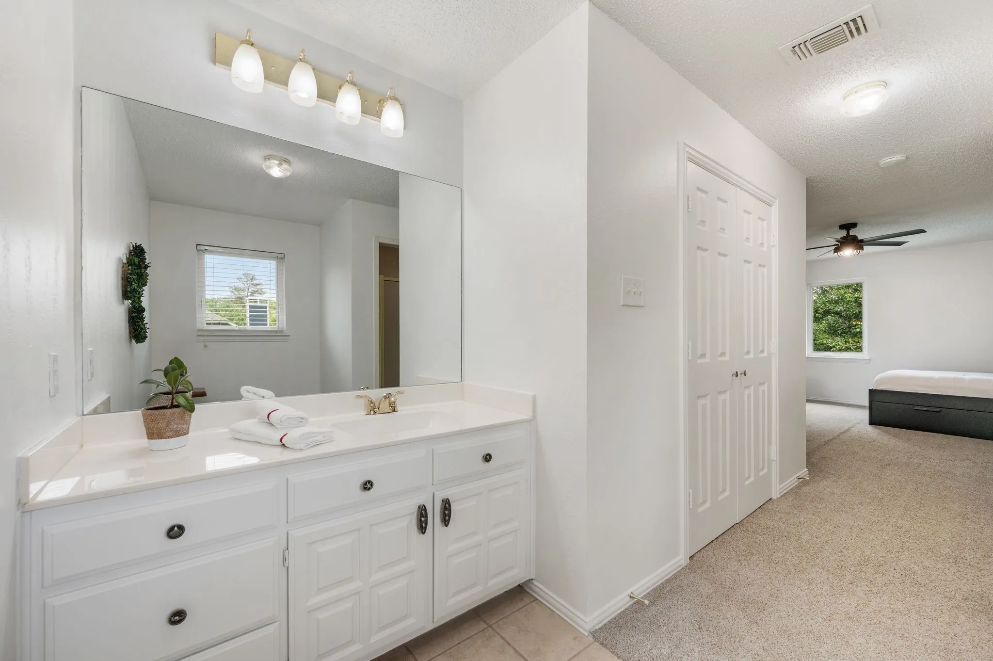 Upstairs en-suite bath has tile flooring and a walk in shower, plus a big wardrobe closet with lots of shelving to keep you organized.