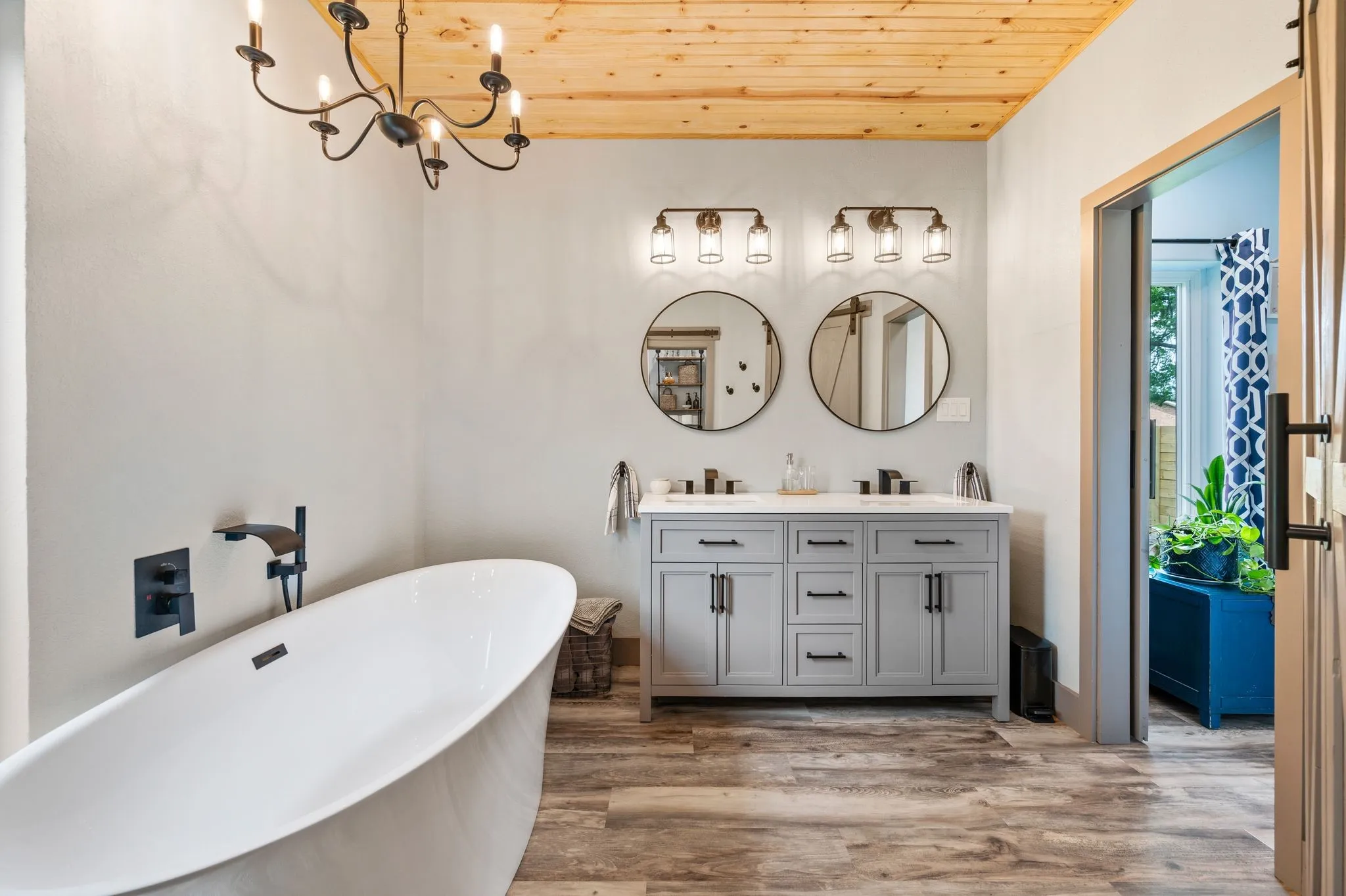 Modern farmhouse luxury awaits in this Primary en-suite bath. Outlets are located inside the cabinets; both are GFCI-protected (at the back of the cabinets).