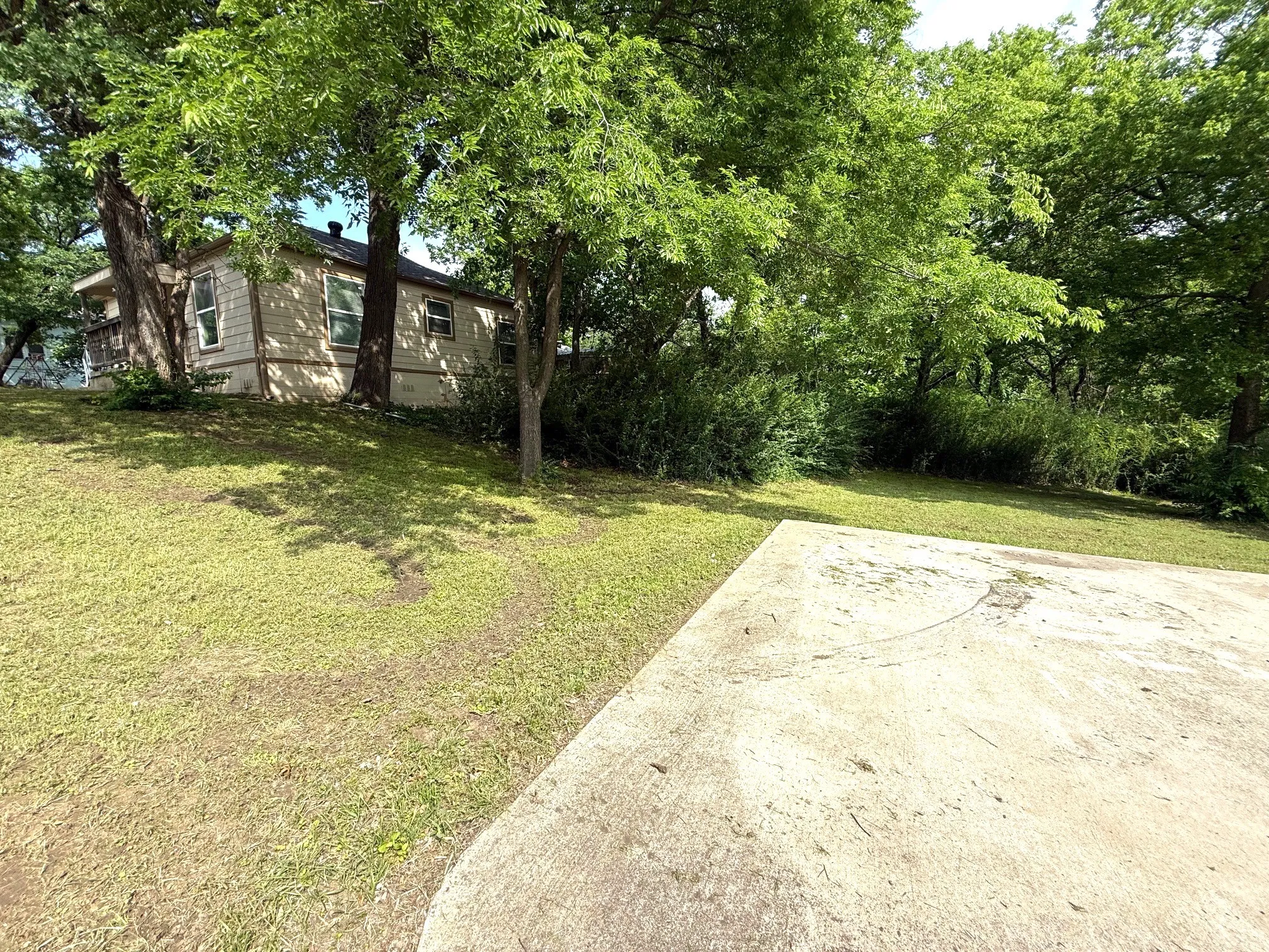 Side view of driveway, house, and yard