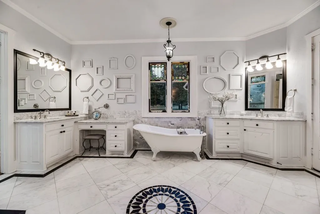 Clawfoot tub, marble flooring, detailed stainglass windows