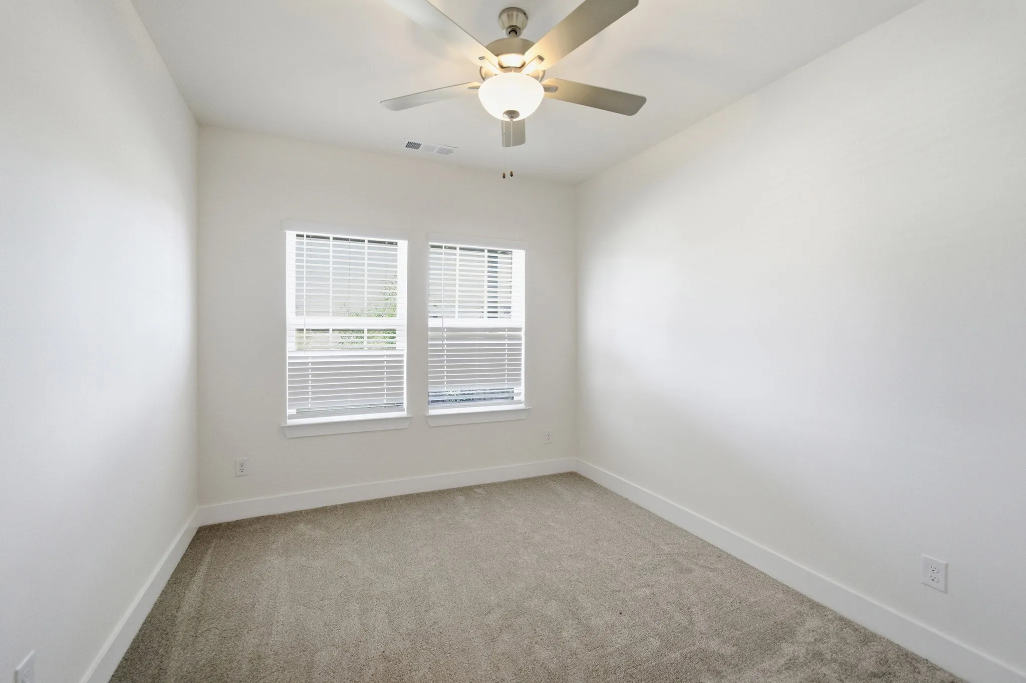Neutral-toned carpeting paired with crisp white walls
