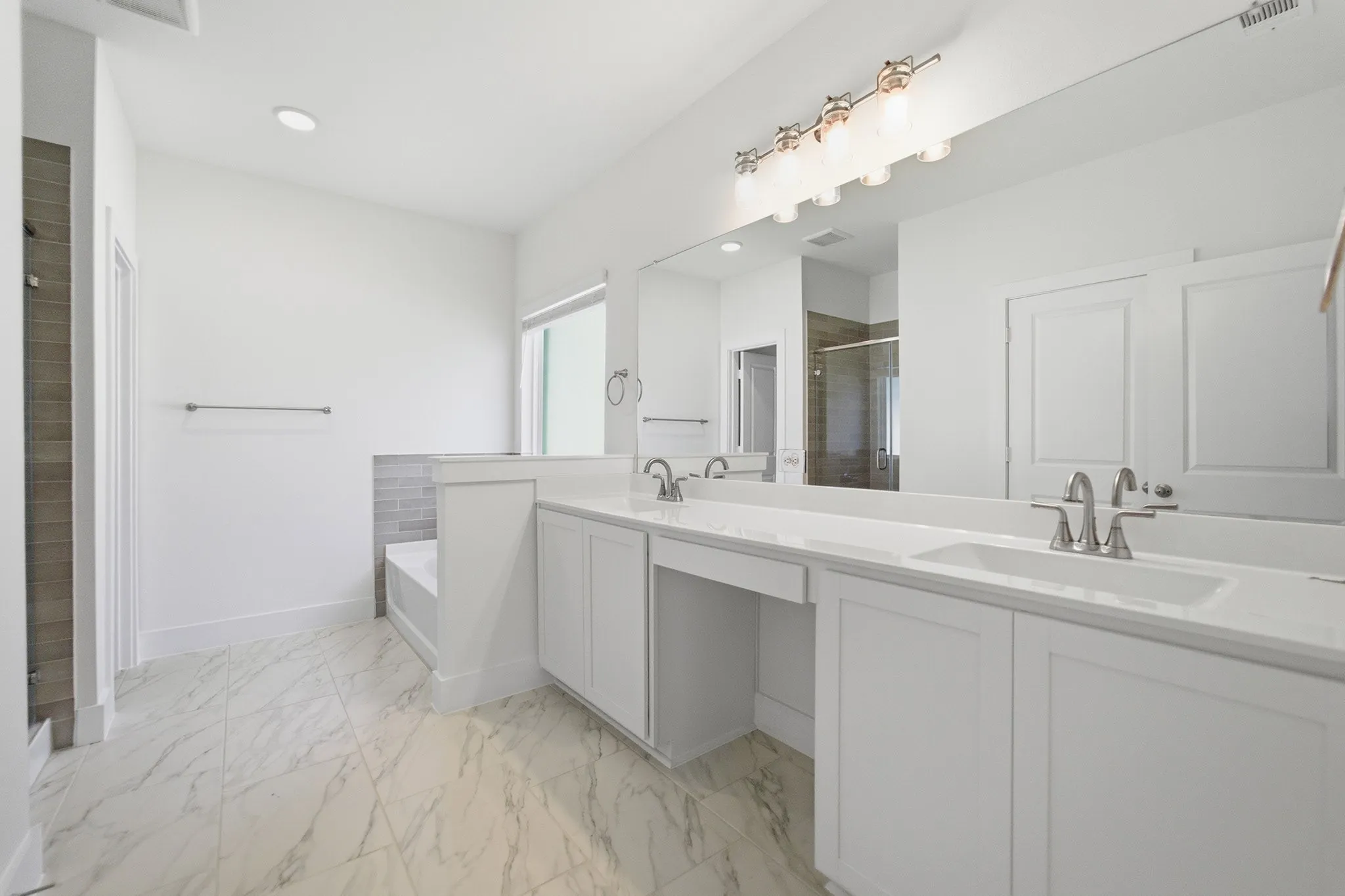 Dual white vanities with integrated sinks and chrome fixtures