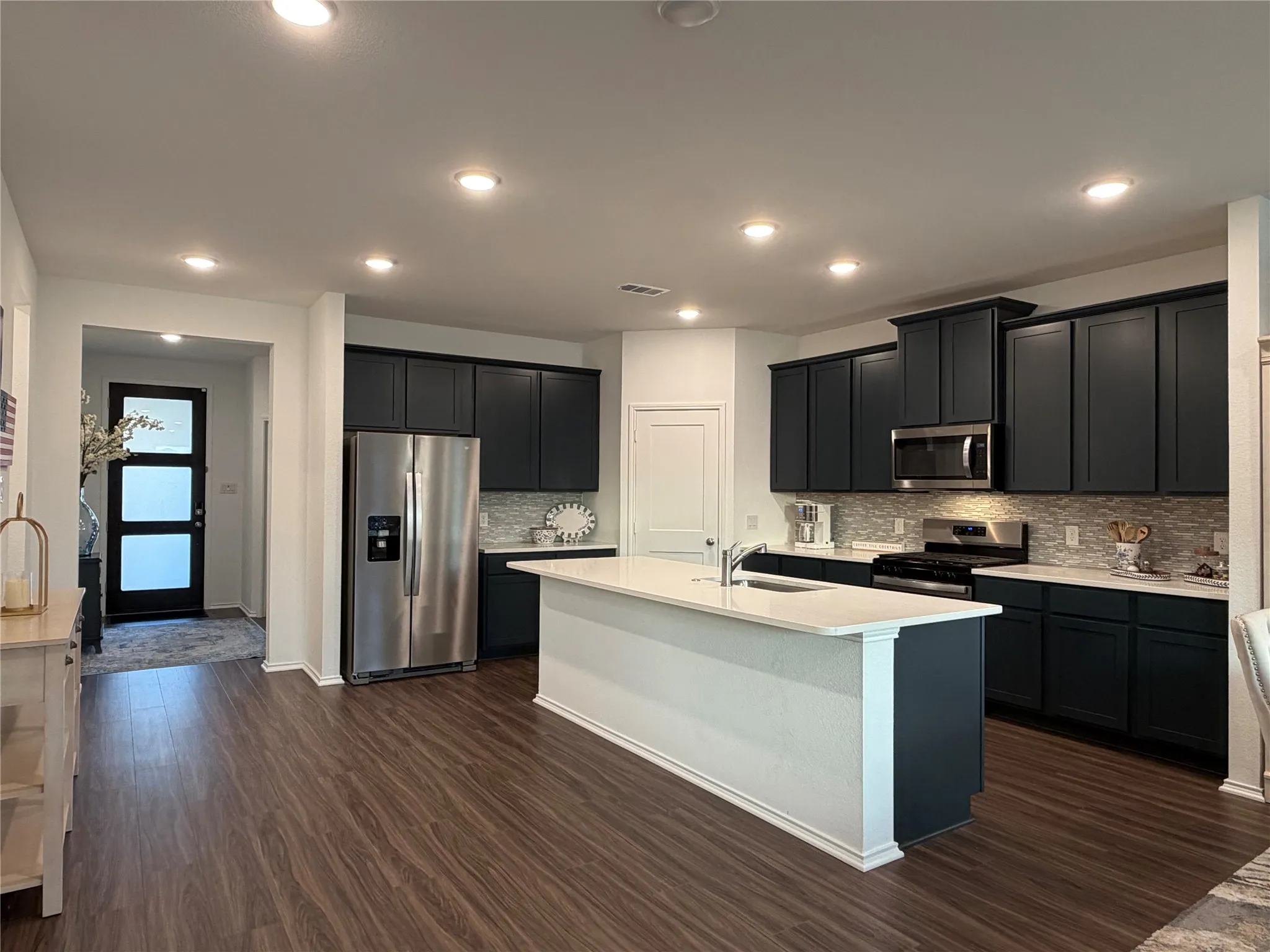 You’ll Love Gathering in the Kitchen, Which Centers Around a Massive Frost White Quartz Island with Breakfast Bar
