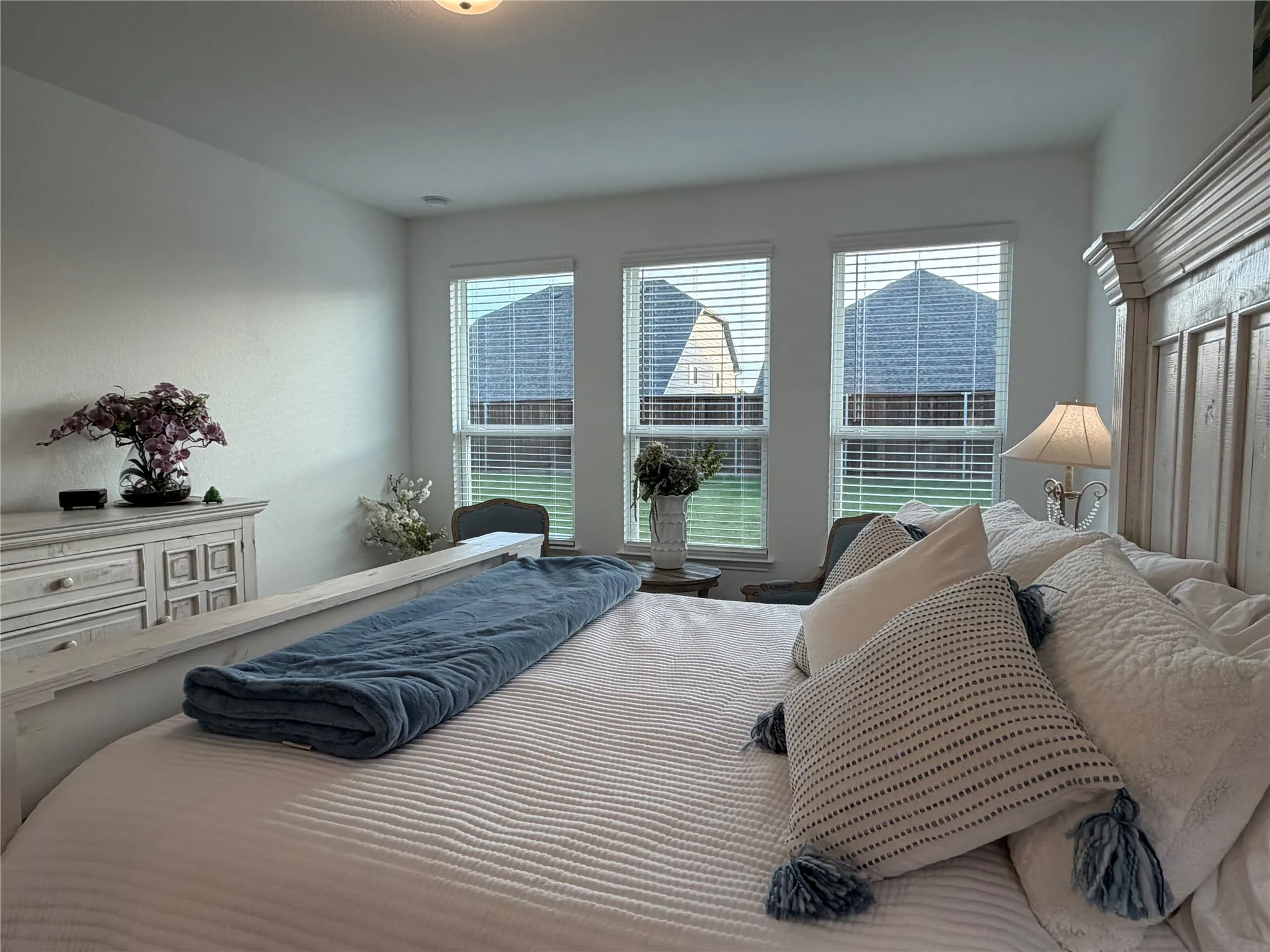 Primary Bedroom with Sitting Area by Wall of Windows