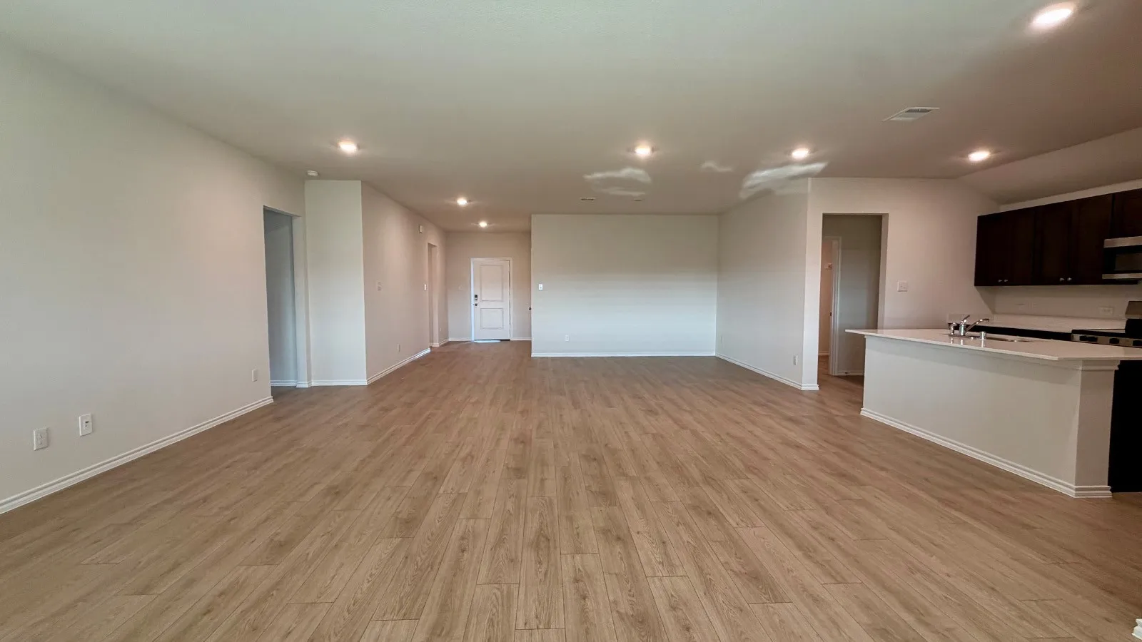 Spacious interior featuring wood-finish flooring, recessed lighting, and light-toned walls
