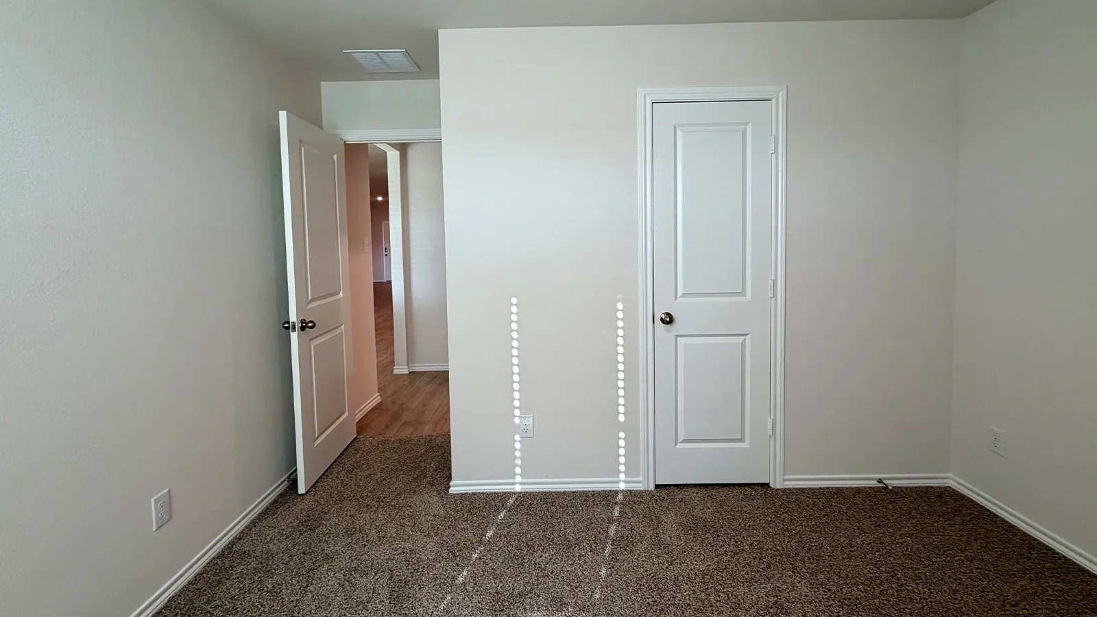 Neutral toned walls complement plush carpeting