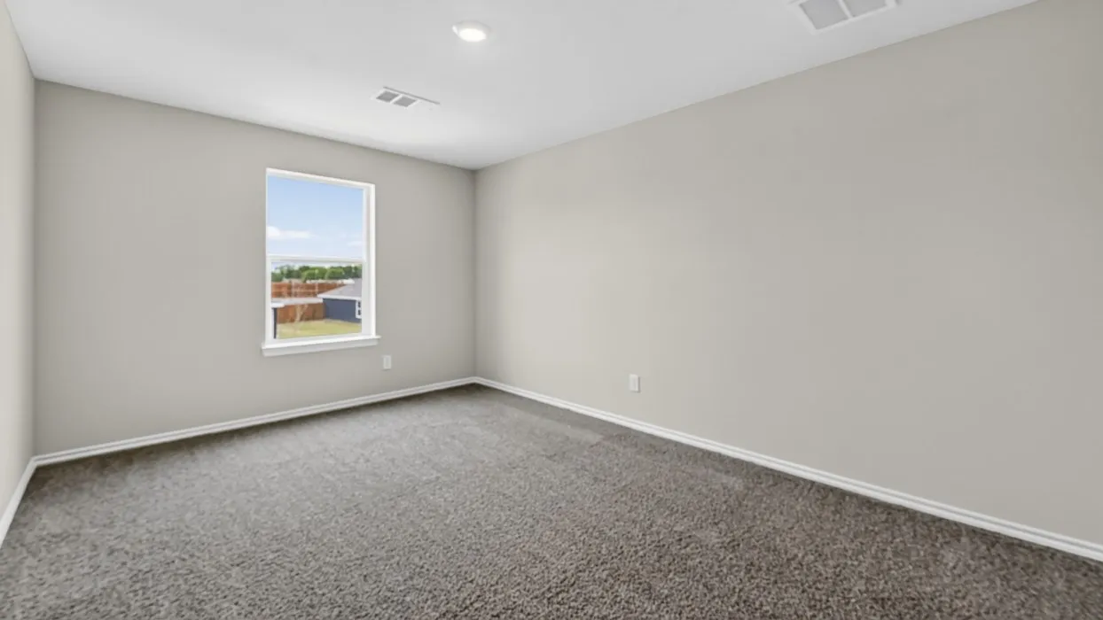 Neutral tone walls with white trim, gray carpeting, a single window, and a recessed ceiling light