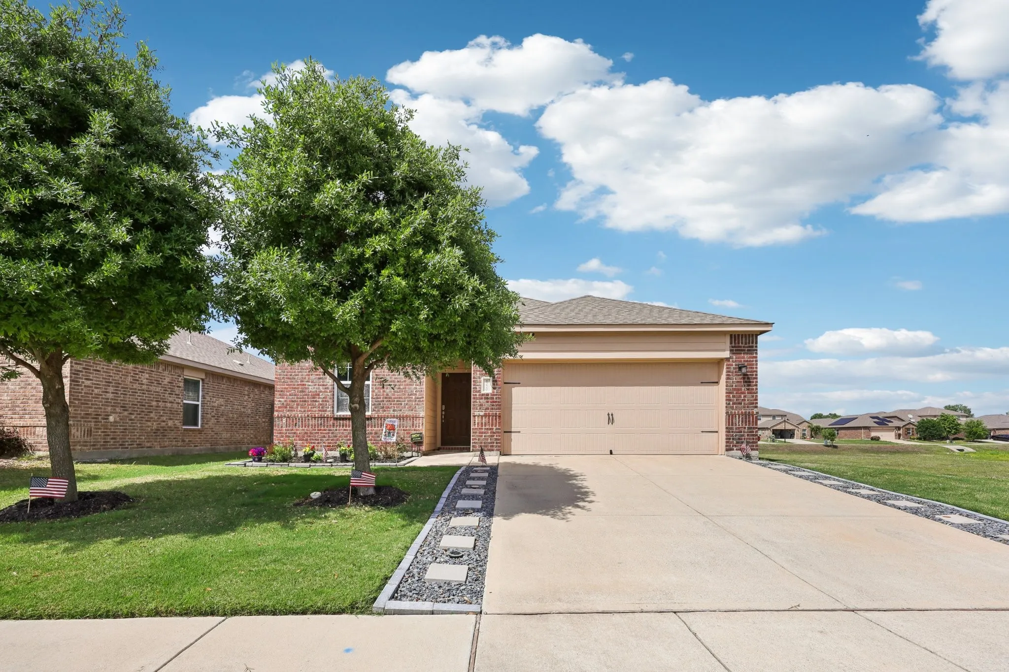 Beautiful lawn, flower beds, walk ways with solar lighting on both sides of the driveway, and mature shade trees.