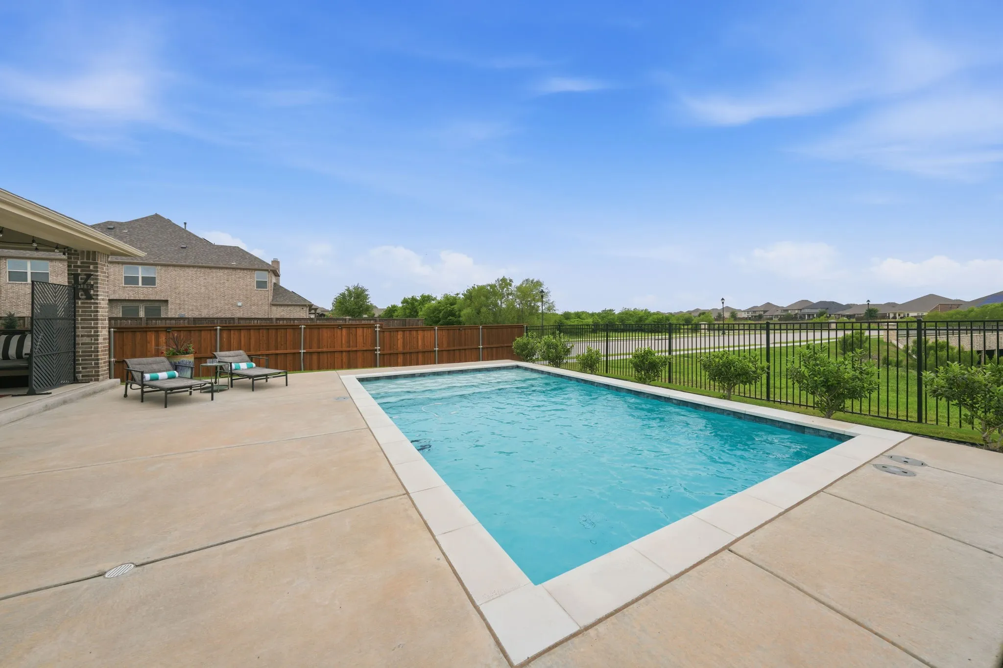 Pool is 3-5 ft. deep with sunbathing deck and water features