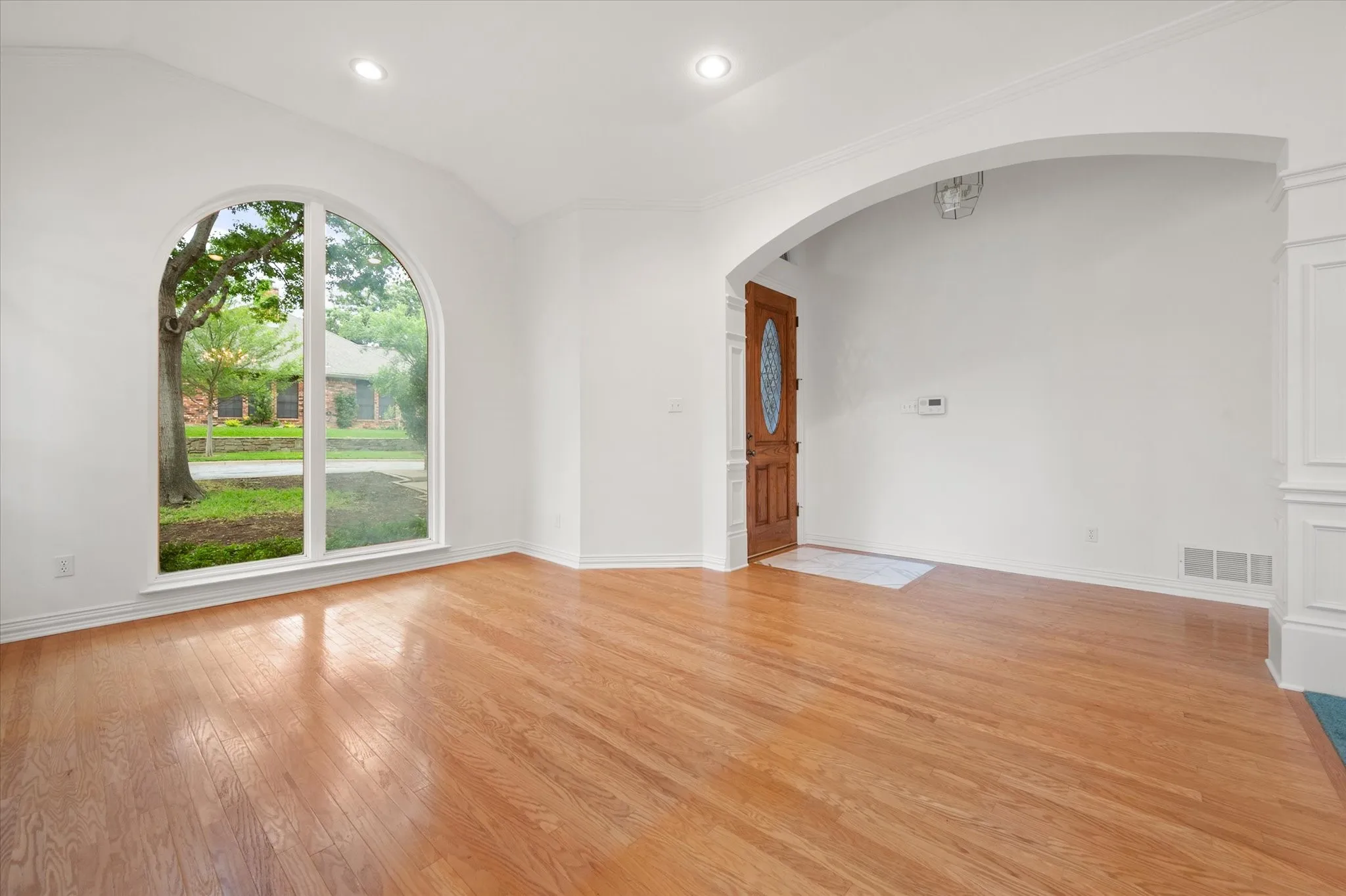 Front entry and living room with hardwood flooring