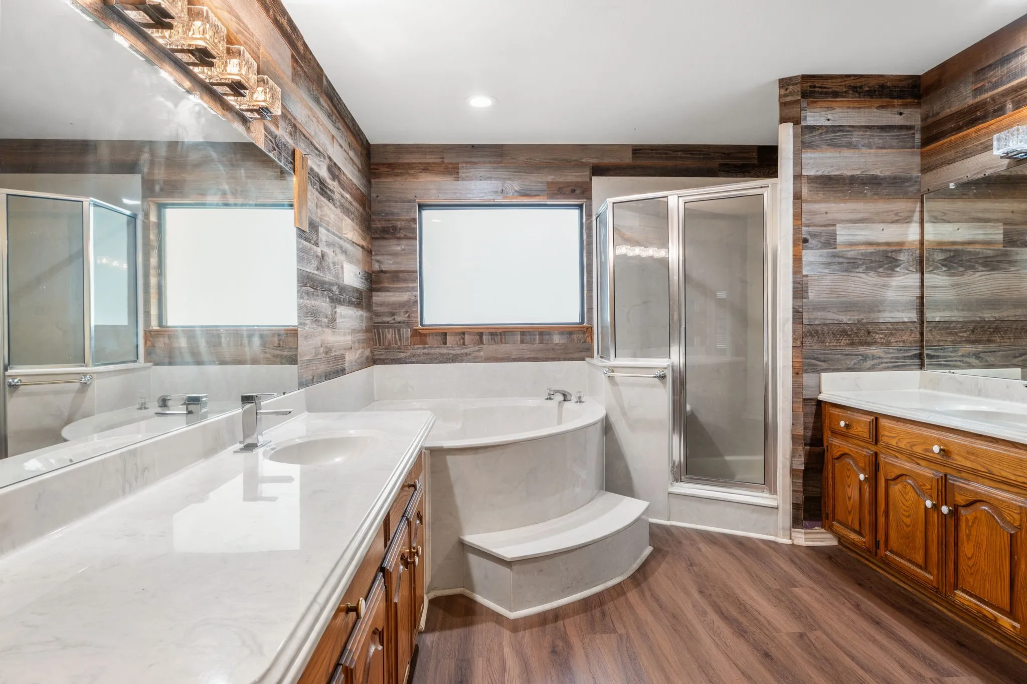 Bathroom with wood-finish flooring and full wood-plank wall treatment