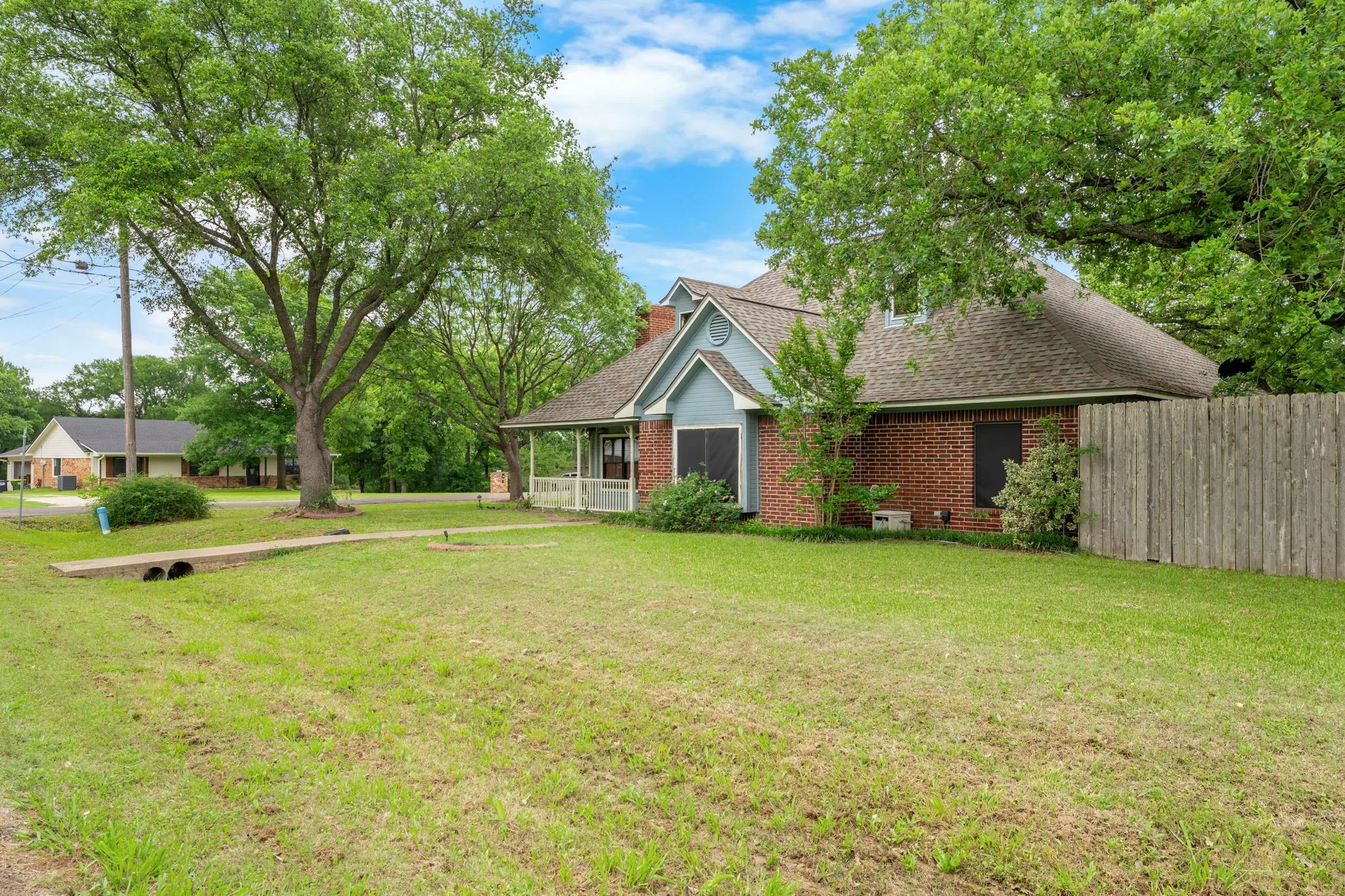 Brick exterior with a covered front porch and a prominent gable