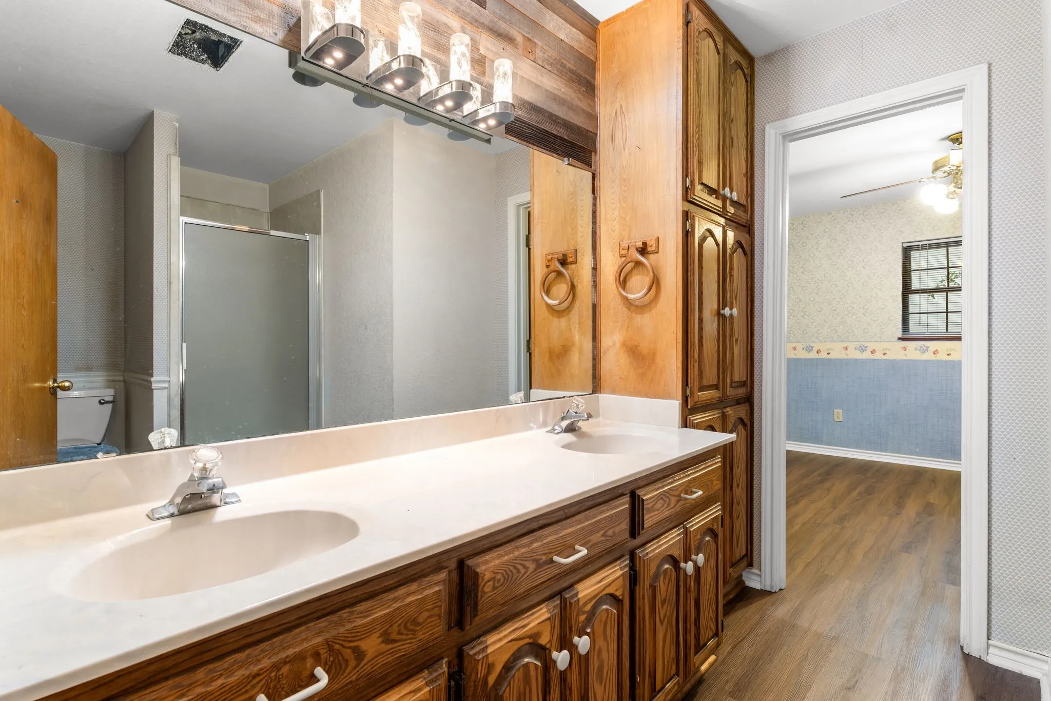 Bathroom featuring a dual vanity with integrated sinks and a light-colored countertop