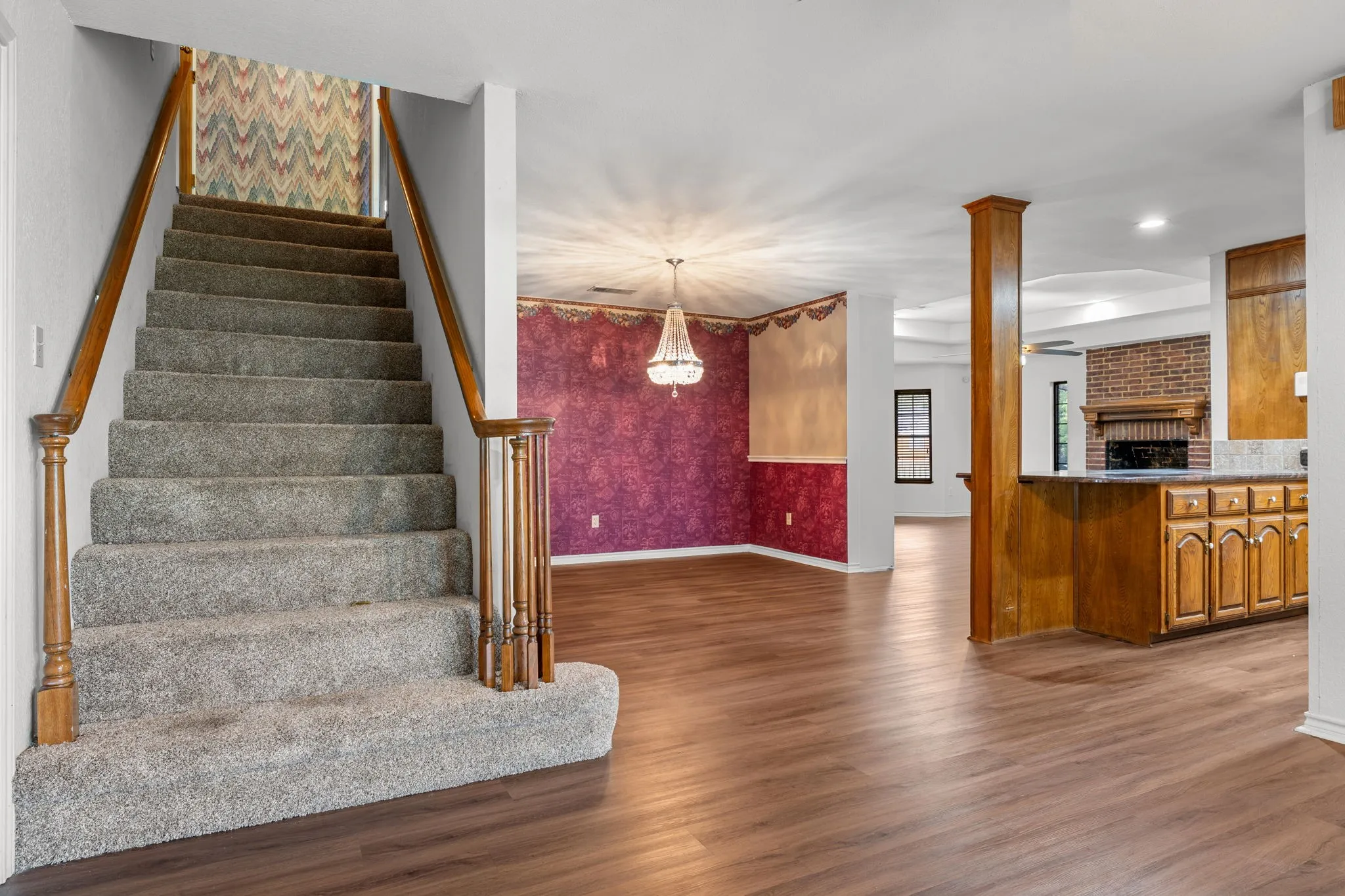 Carpeted staircase with wood-finish handrails and balusters