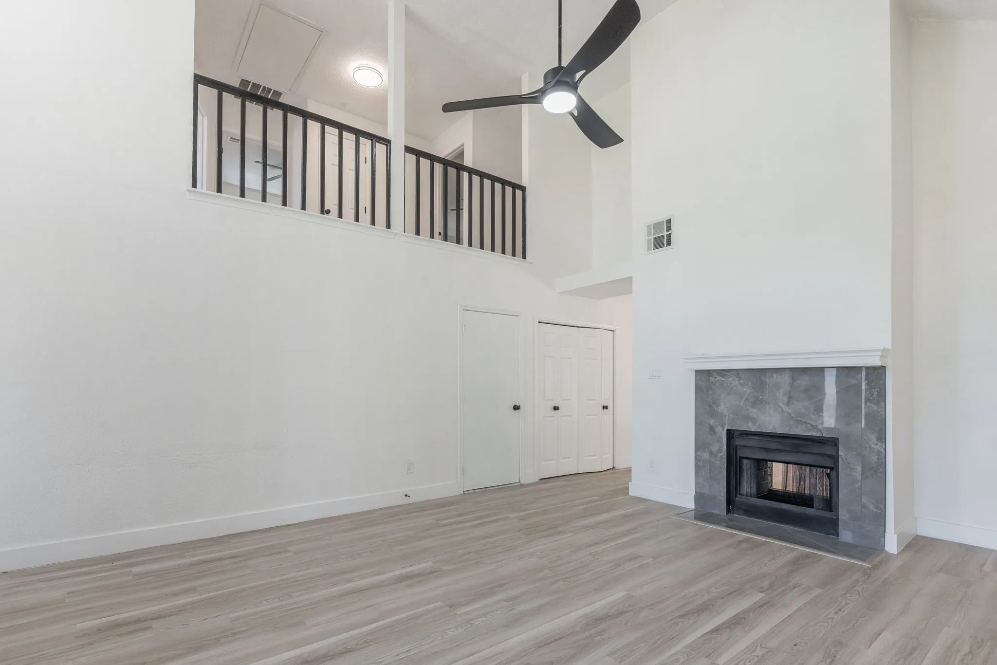 Vaulted ceilings complementing a modern black ceiling fan