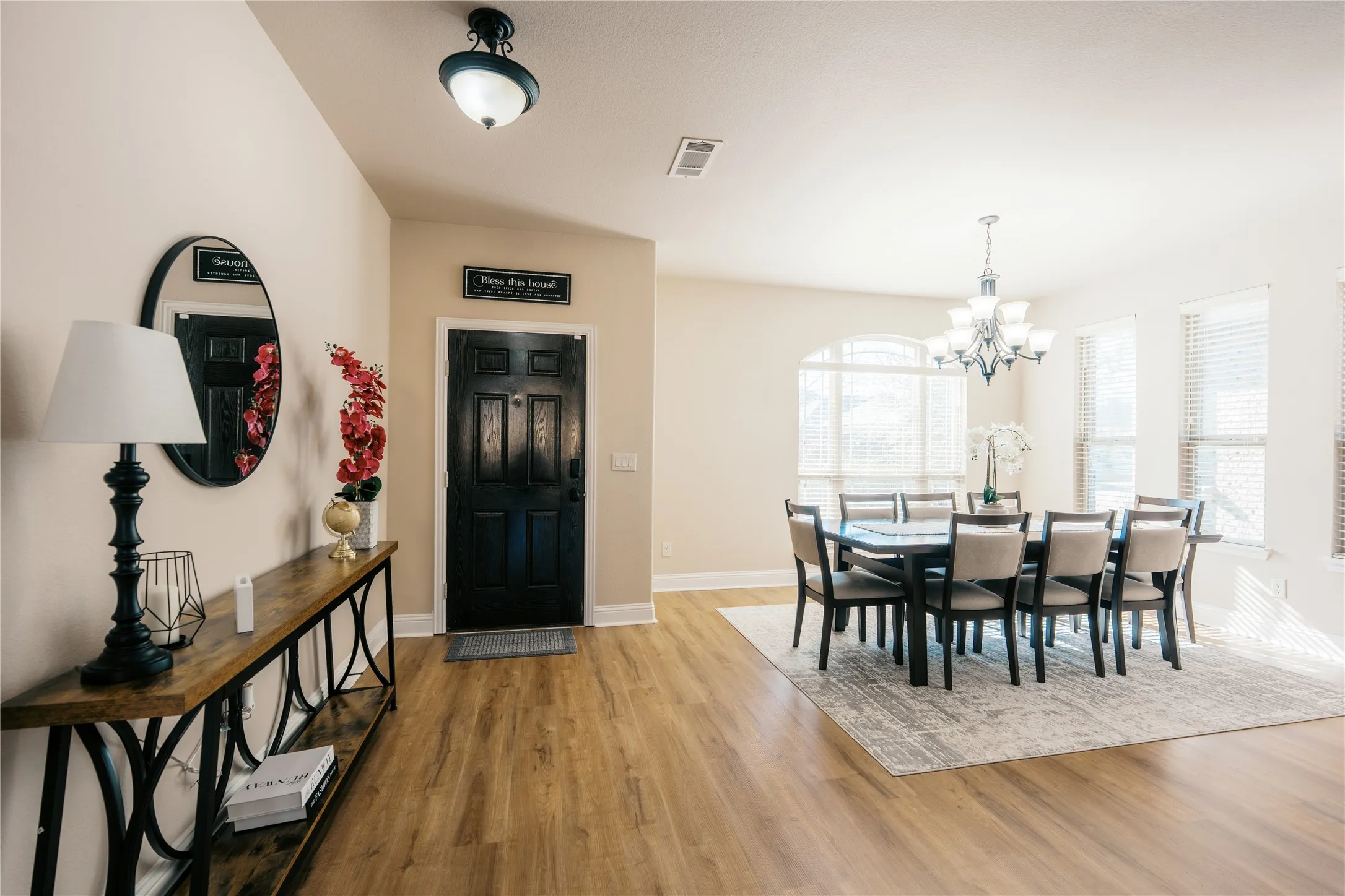 Entryway with wood-finish flooring opening to a dining area
