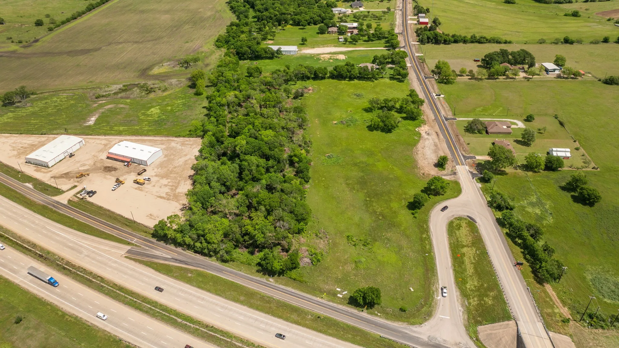 Expansive commercial land featuring two substantial warehouse structures